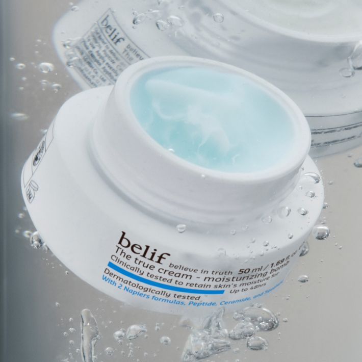 A jar of belif Moisturizing Bomb with no lid, underwater surrounded by bubbles.