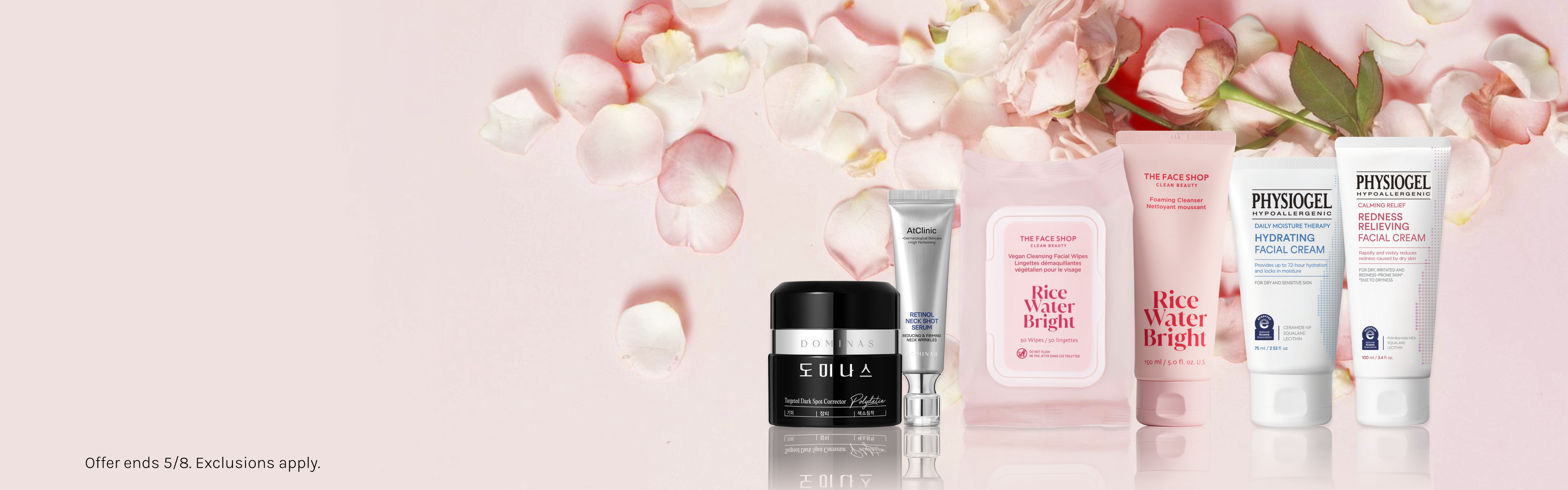 Skincare products from The Face Shop and Physiogel on a pink background with rose petals.