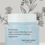 A light blue jar of THE FACE SHOP vegan moisture blending cream with a white lid, against a background of botanical illustrations.