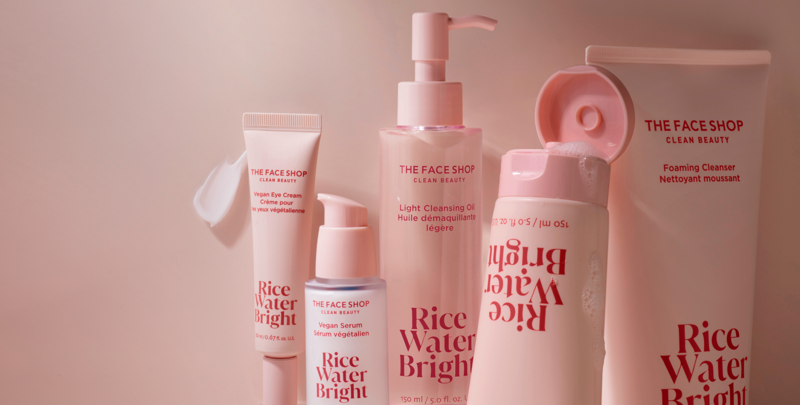 A wide banner portrait of the Rice Water Bright Collection, products leaning together and Foaming Cleanser covered in bubbles.