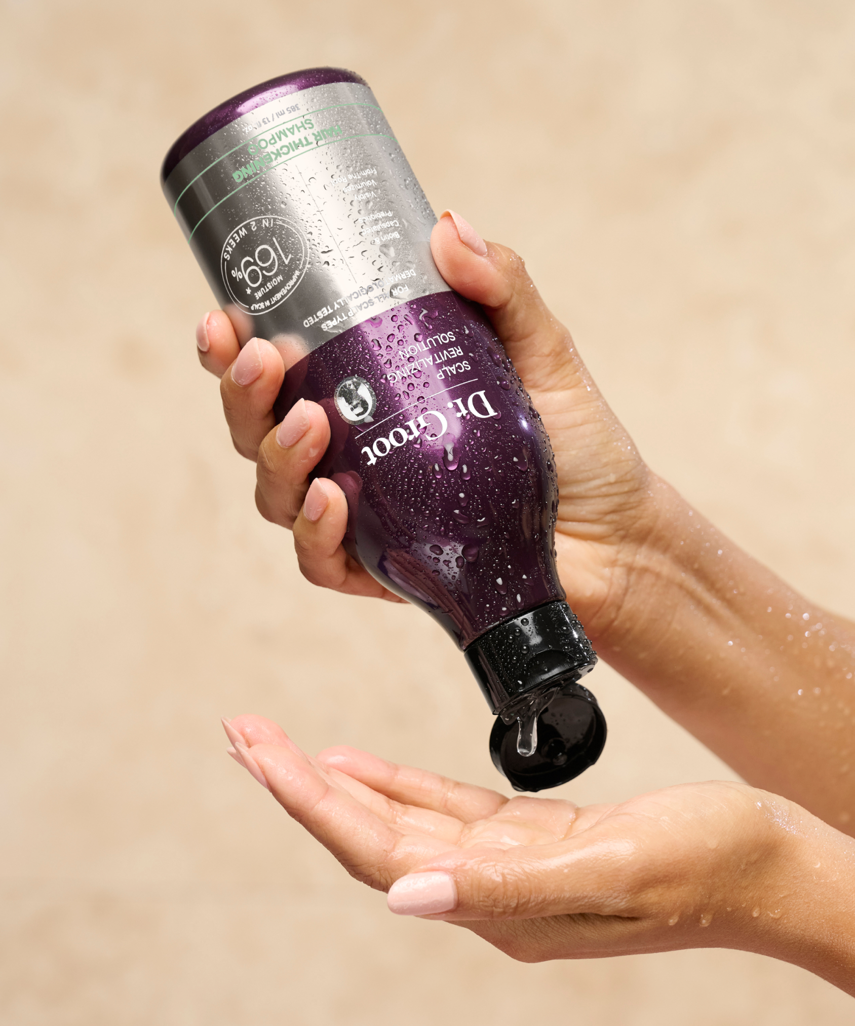 A model pours a dollop of Dr. Groot Hair Thickening Shampoo out onto her outstretched palm.