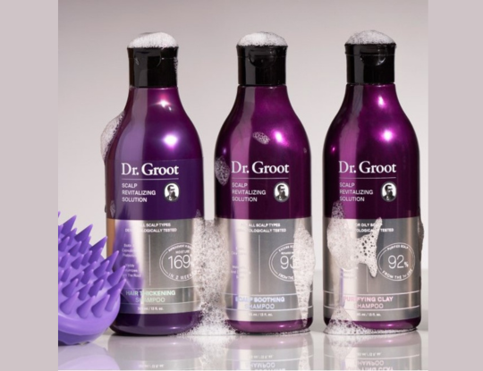 Three purple bottles of Dr. Groot Scalp Revitalizing Solution shampoos: Soothing, Purifying Clay, and Hair Thickening.