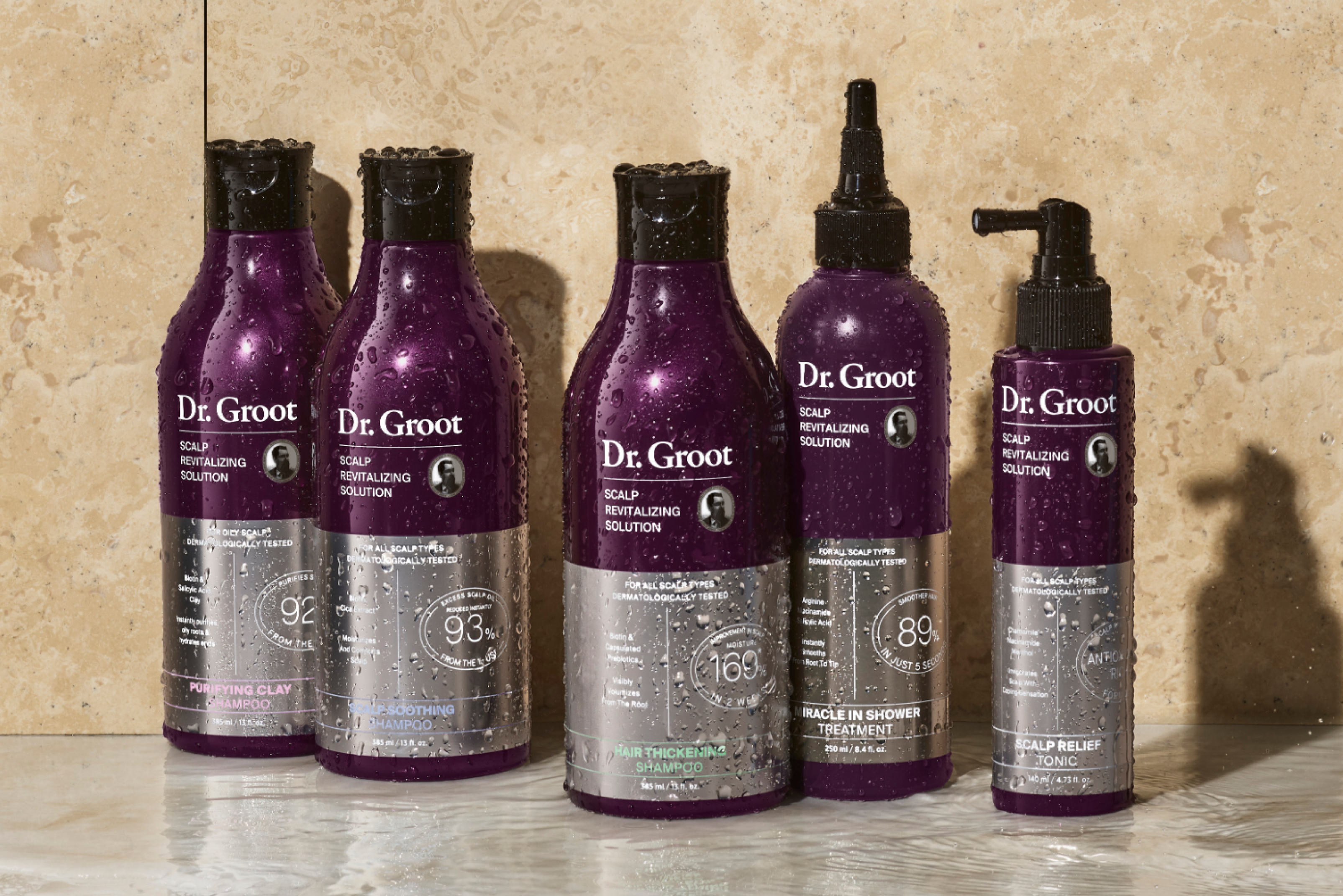 A range of Dr. Groot scalp care and shampoo products sit on a bathroom shelf.
