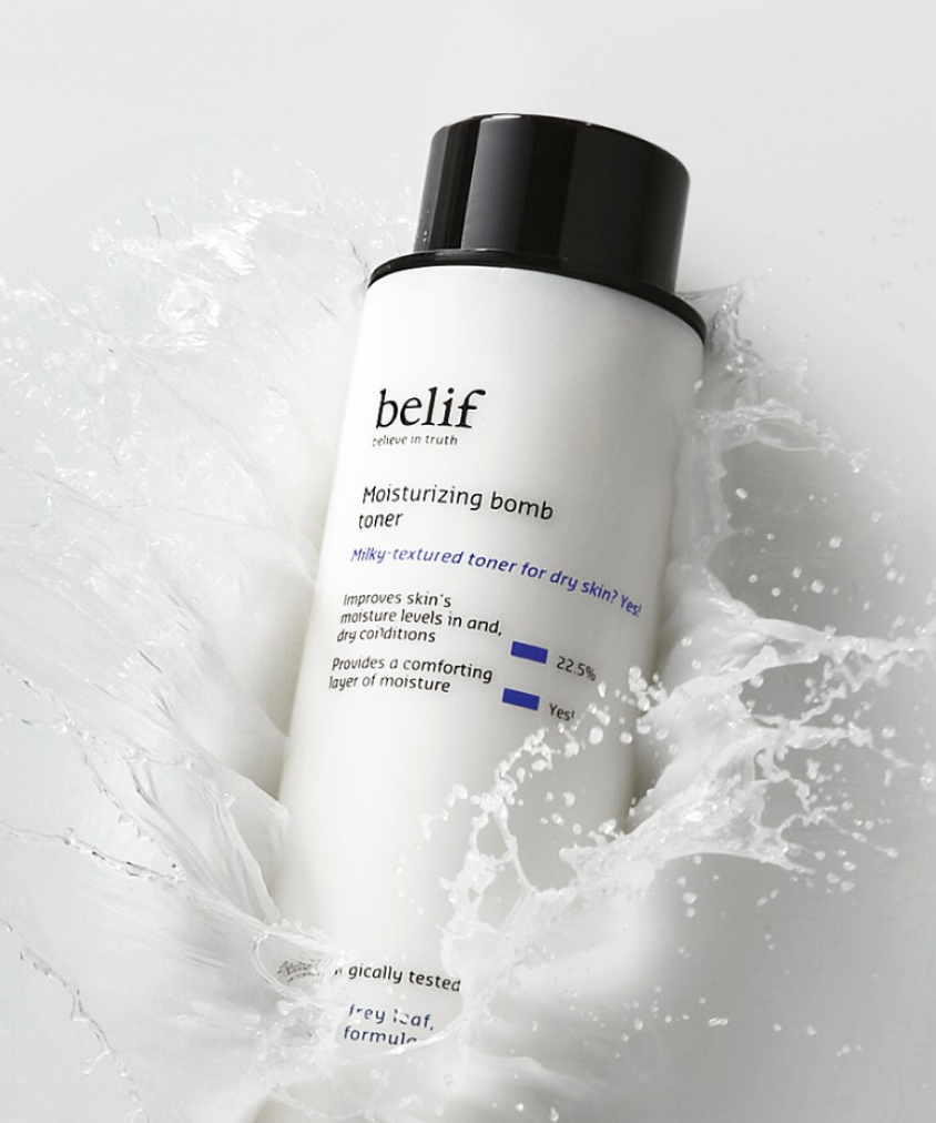 A bottle of belif moisturizing bomb toner splashes into a milky liquid.