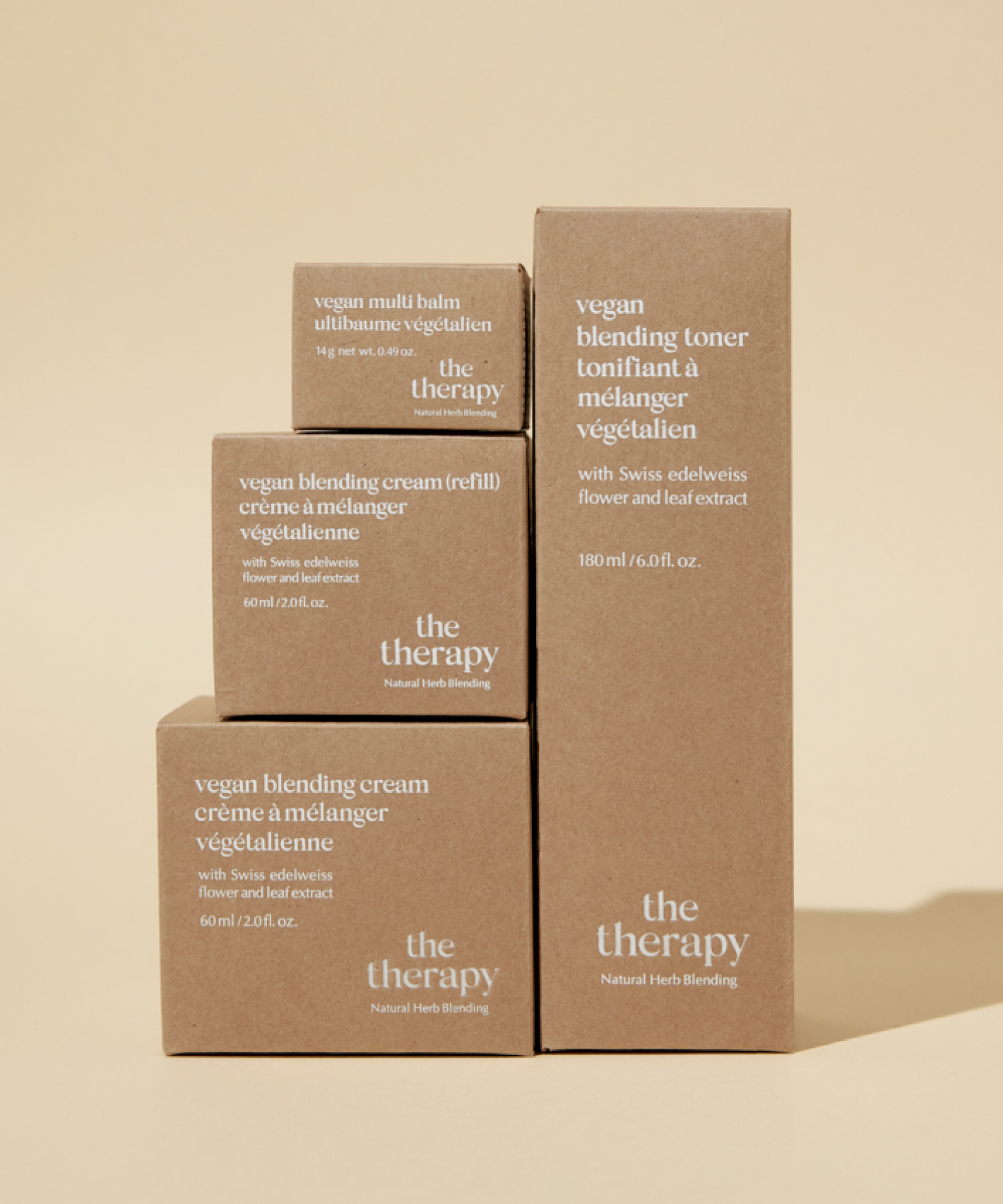 Four boxes of The Face Shop The Therapy products standing on top of each other on a light yellow background.