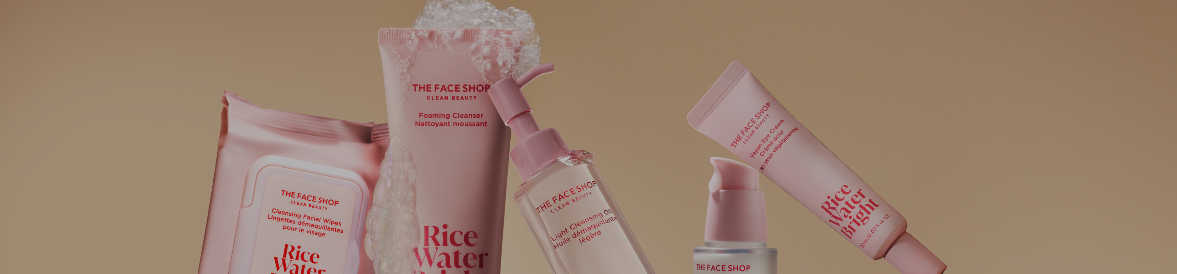 A wide banner portrait of the Rice Water Bright Collection, products leaning together and Foaming Cleanser covered in bubbles.