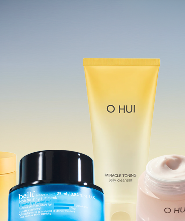 A selection of skincare products including tubes and jars from belif and o hui brands, displayed against a soft gradient blue and yellow background.