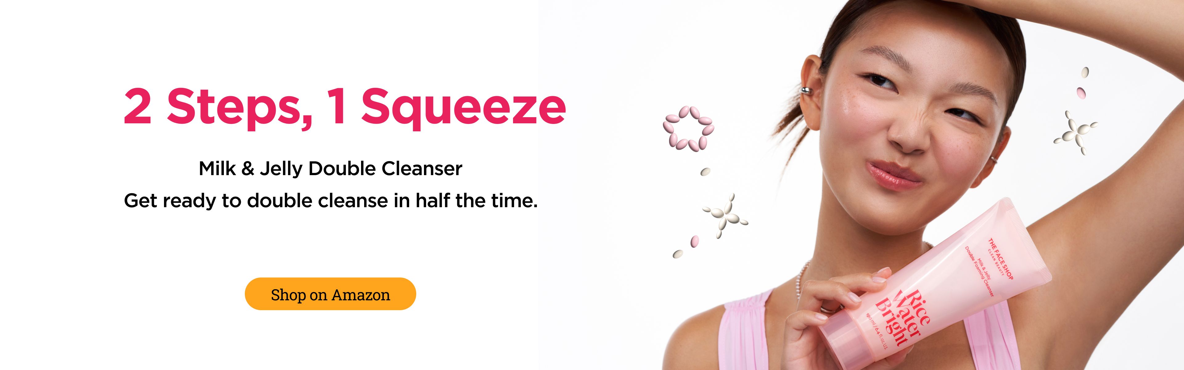 A young woman with a playful expression holds a pink tube of "Milk & Jelly Double Cleanser". Text reads "2 Steps, 1 Squeeze. Get ready to double cleanse in half the time. Shop on Amazon."