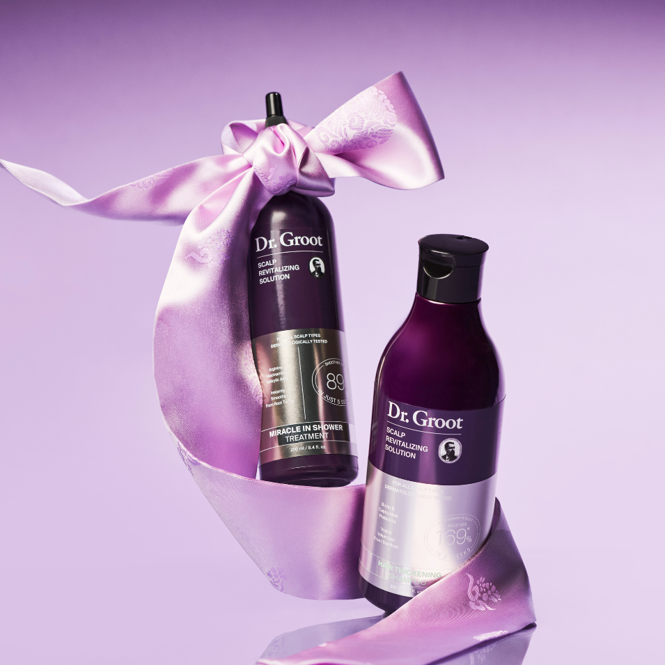Two purple Dr. Groot hair product bottles wrapped with a light purple ribbon on a purple background.