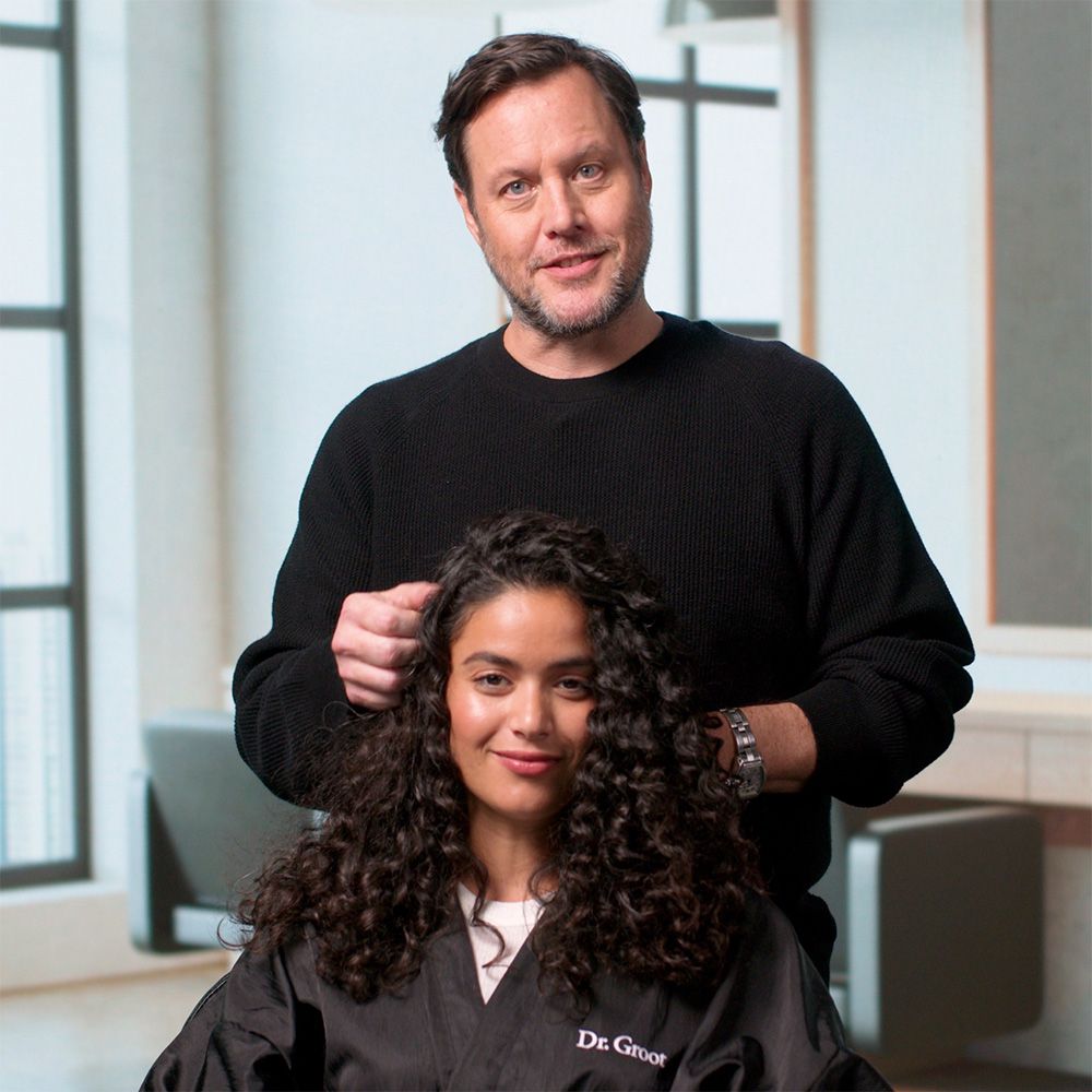 Mark Townsend, a celebrity stylist, styling woman's hair with the Dr. Groot hair products.