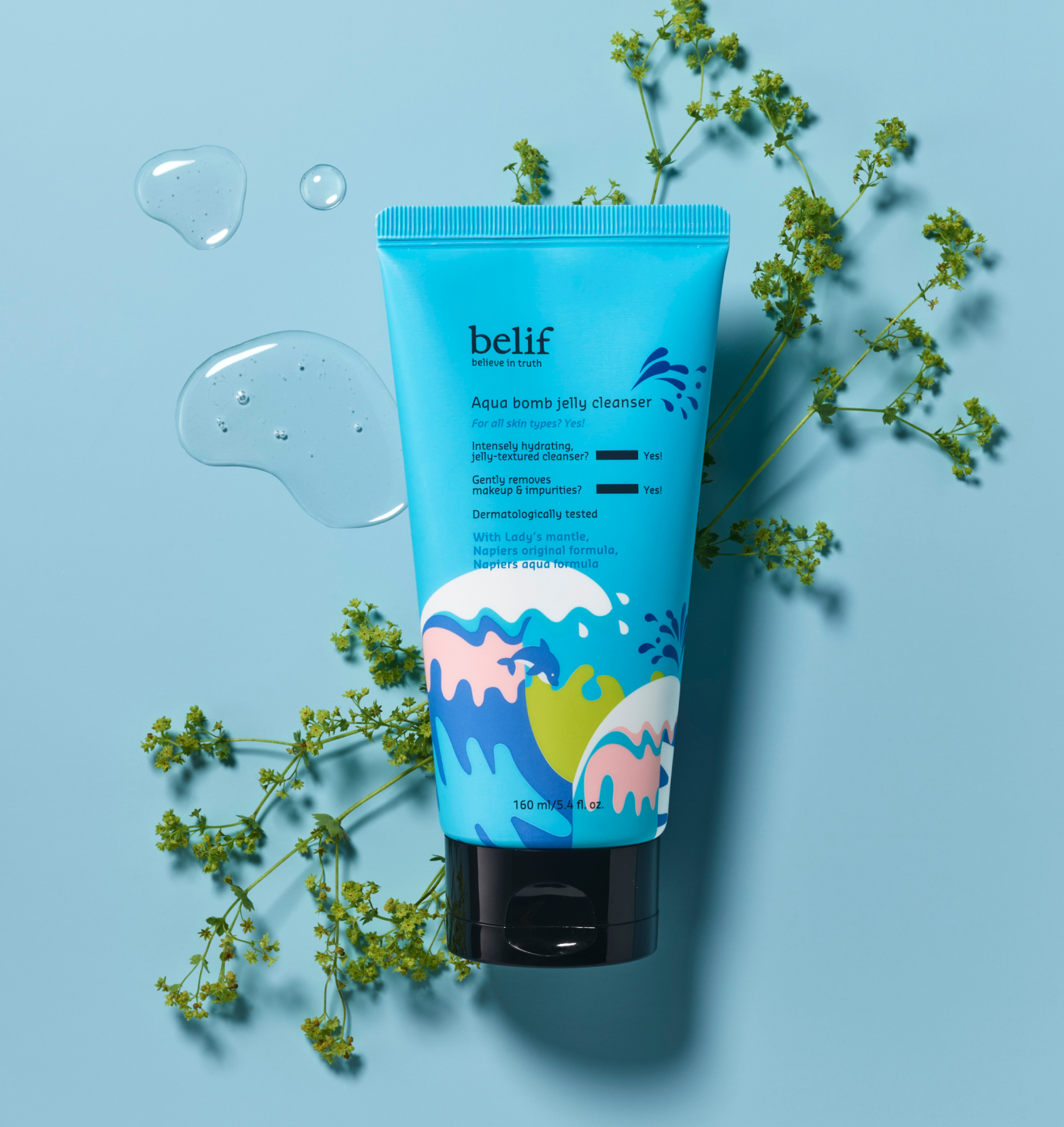 A blue bottle of belif Aqua Bomb Jelly Cleanser lying on a herb twig on a light blue surface with a few drops of the cleanser around it