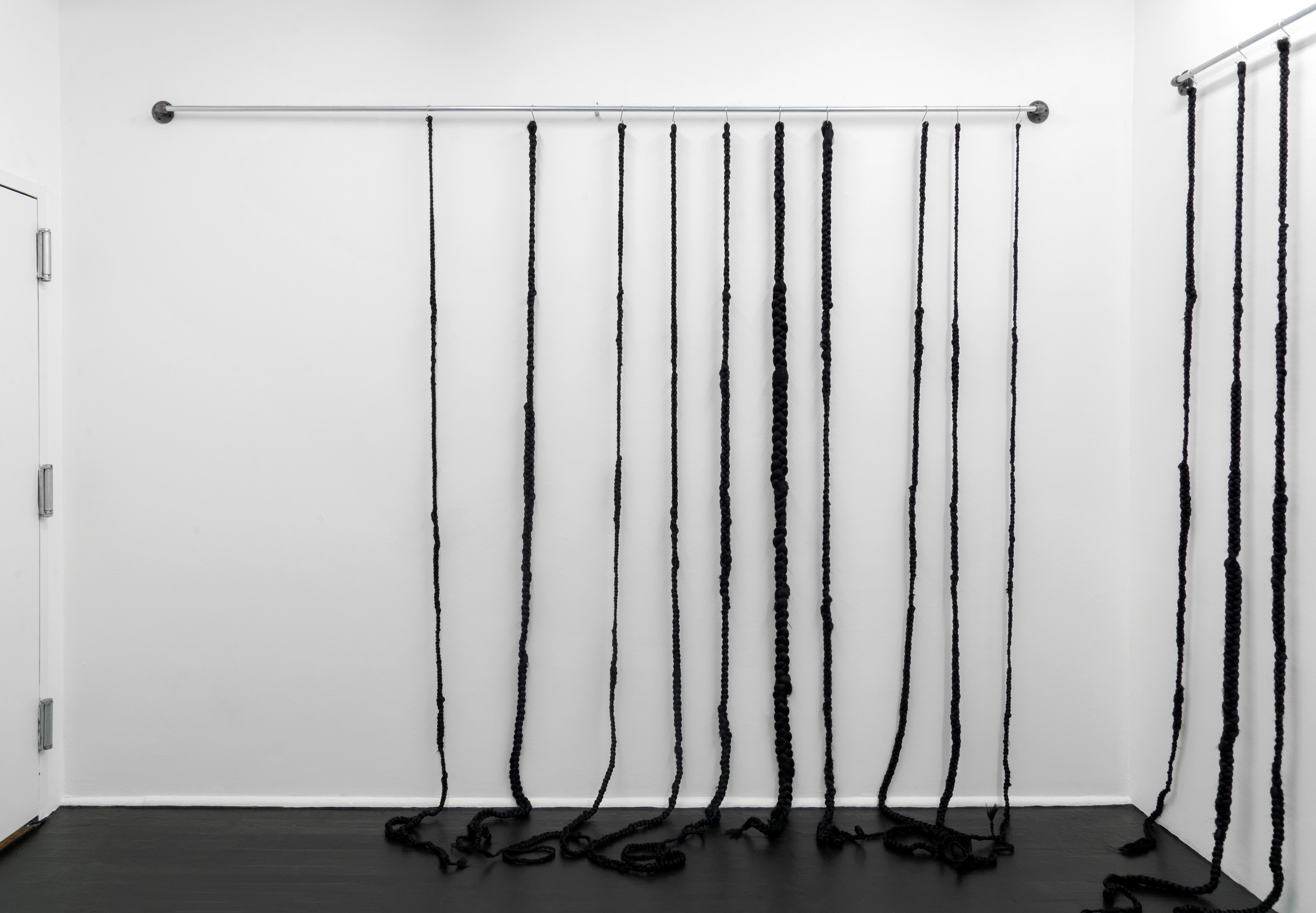 Kaas (Punishment) (2019)
Kanekalon hair, conduit, hooks, hardware
95h x 162w x 18d inches (241.3h x 411.48w x 45.72d cm)
