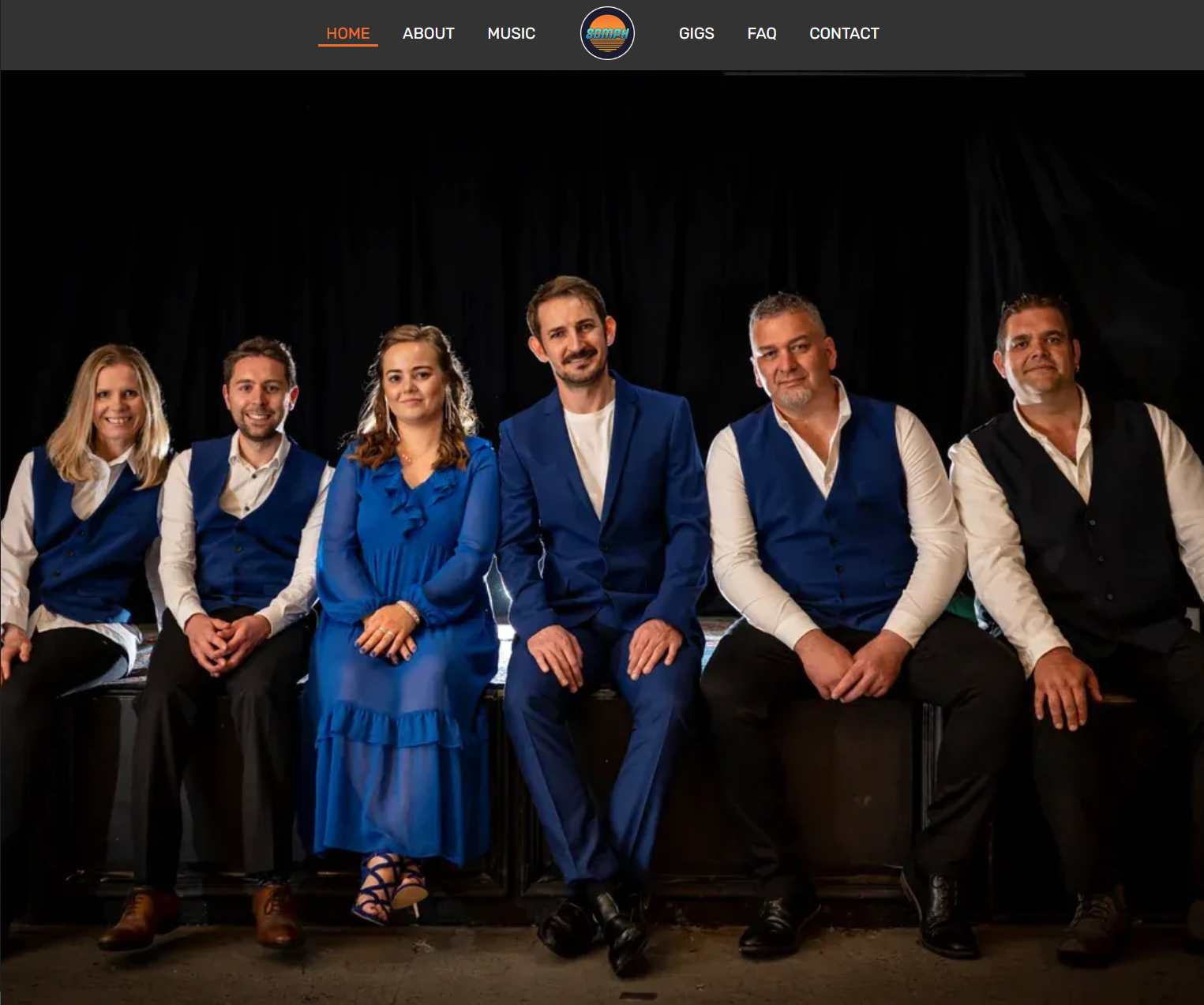 A screenshot of the homepage for the website, showing the band members sitting together.