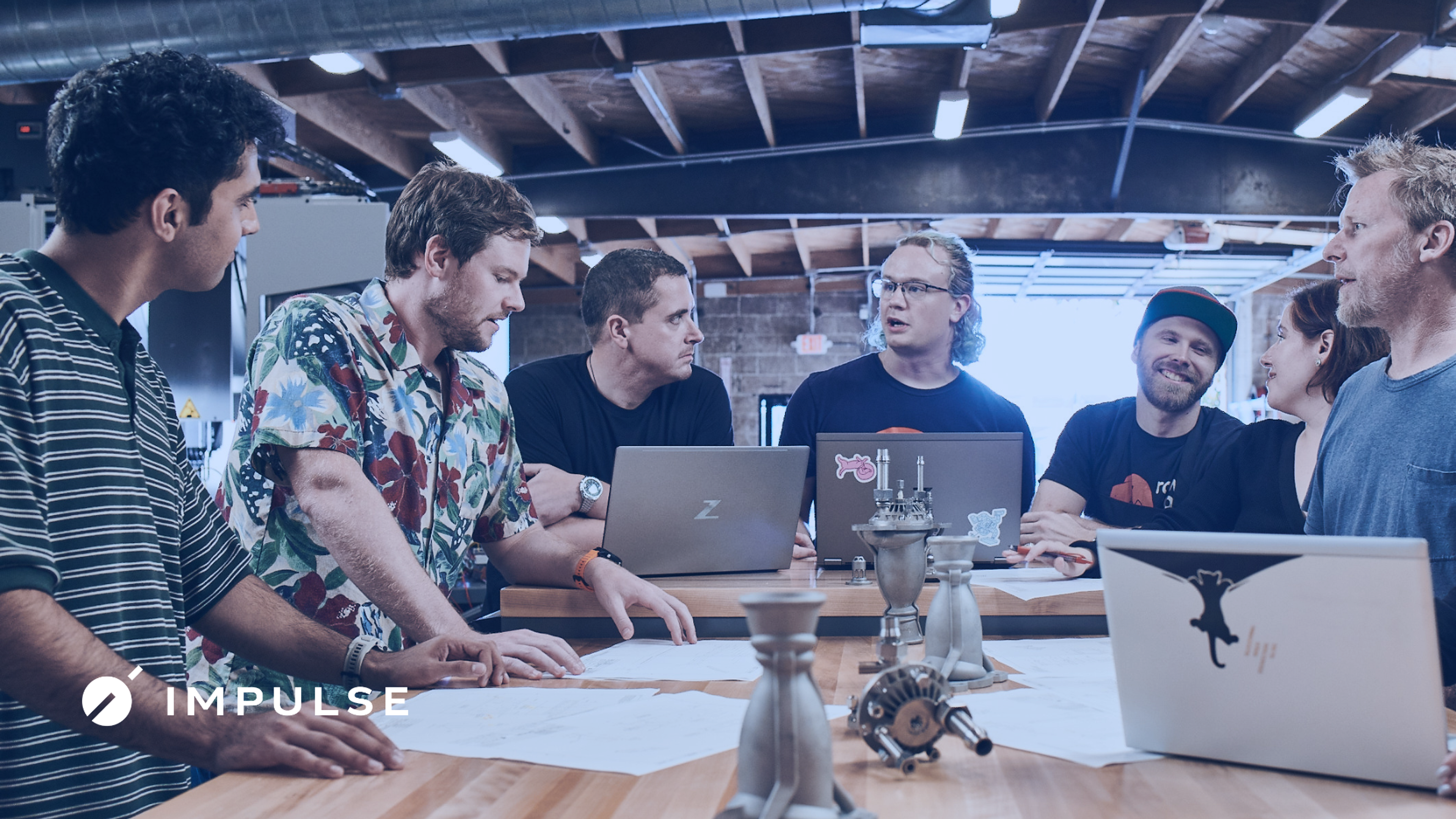 The team meets around the table.