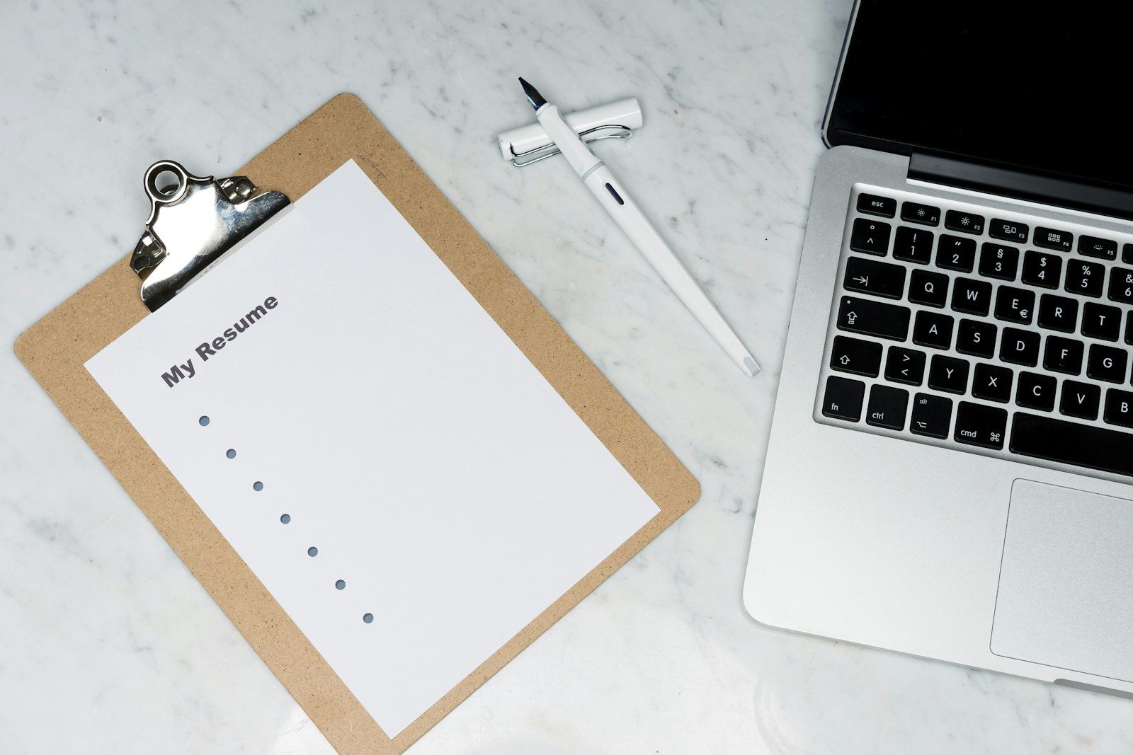 Creative content creator writing hooks on notepad next to phone