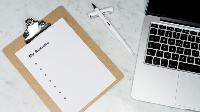 Creative content creator writing hooks on notepad next to phone