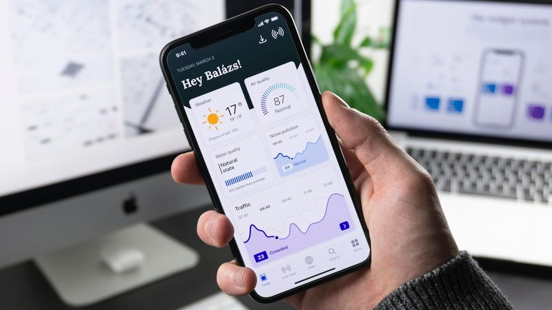 Hands holding phone showing photo gallery on screen