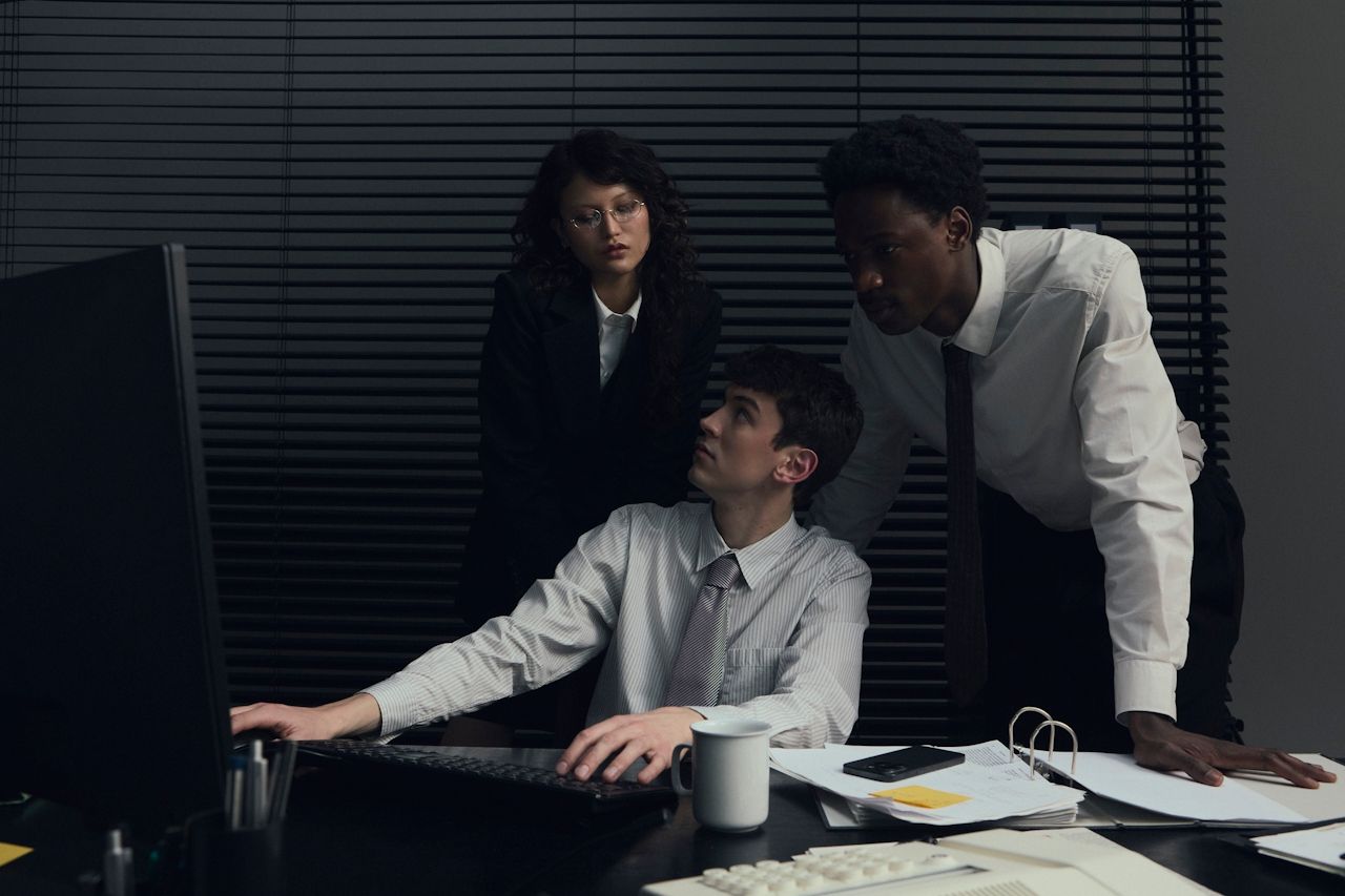 3 confused staff looking at a computer