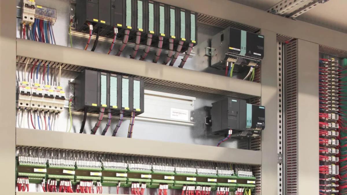 Industrial control cabinet with Siemens PLC modules, wiring, and circuit breakers
