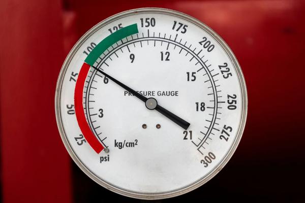 Industrial pressure gauge with the needle reading outside its marked green operating band.