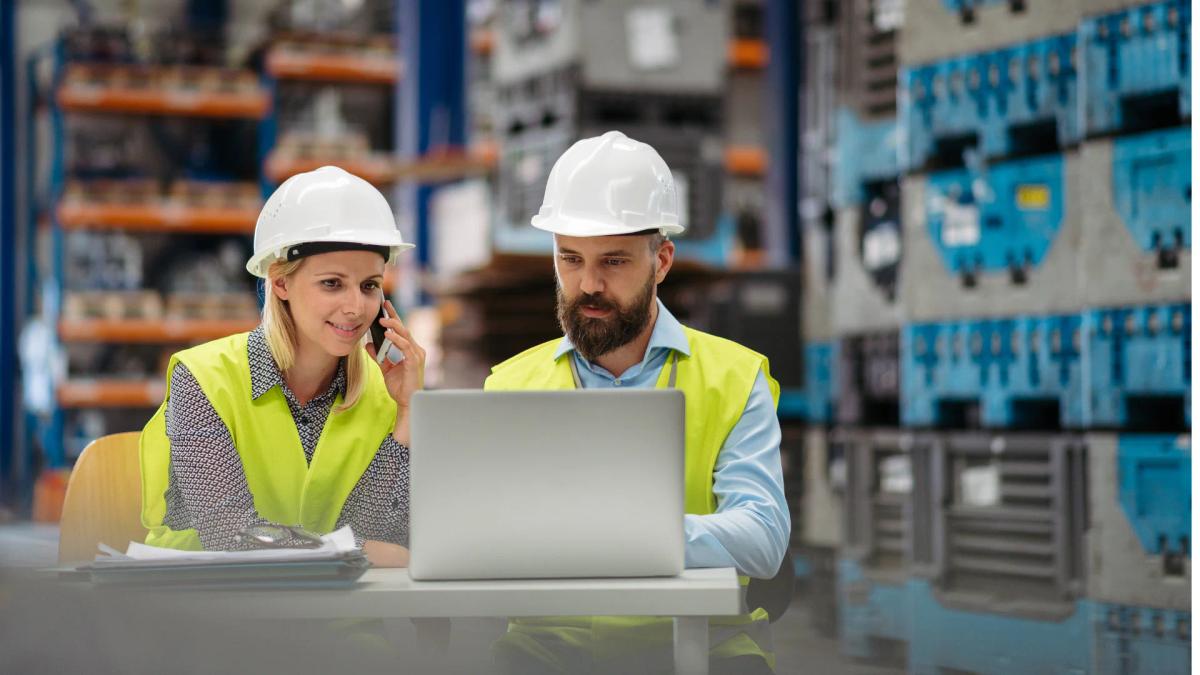 Production, engineering and quality staff reviewing process data together at a plant.