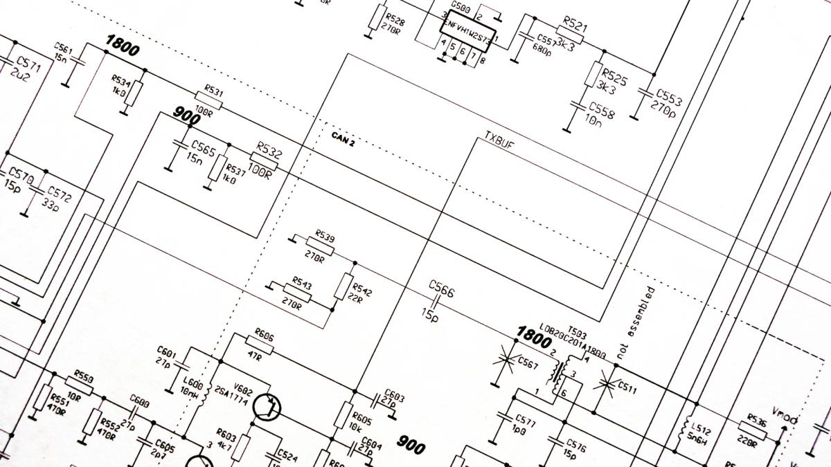 Close-up of a legacy industrial control system circuit schematic with hand-labeled component values