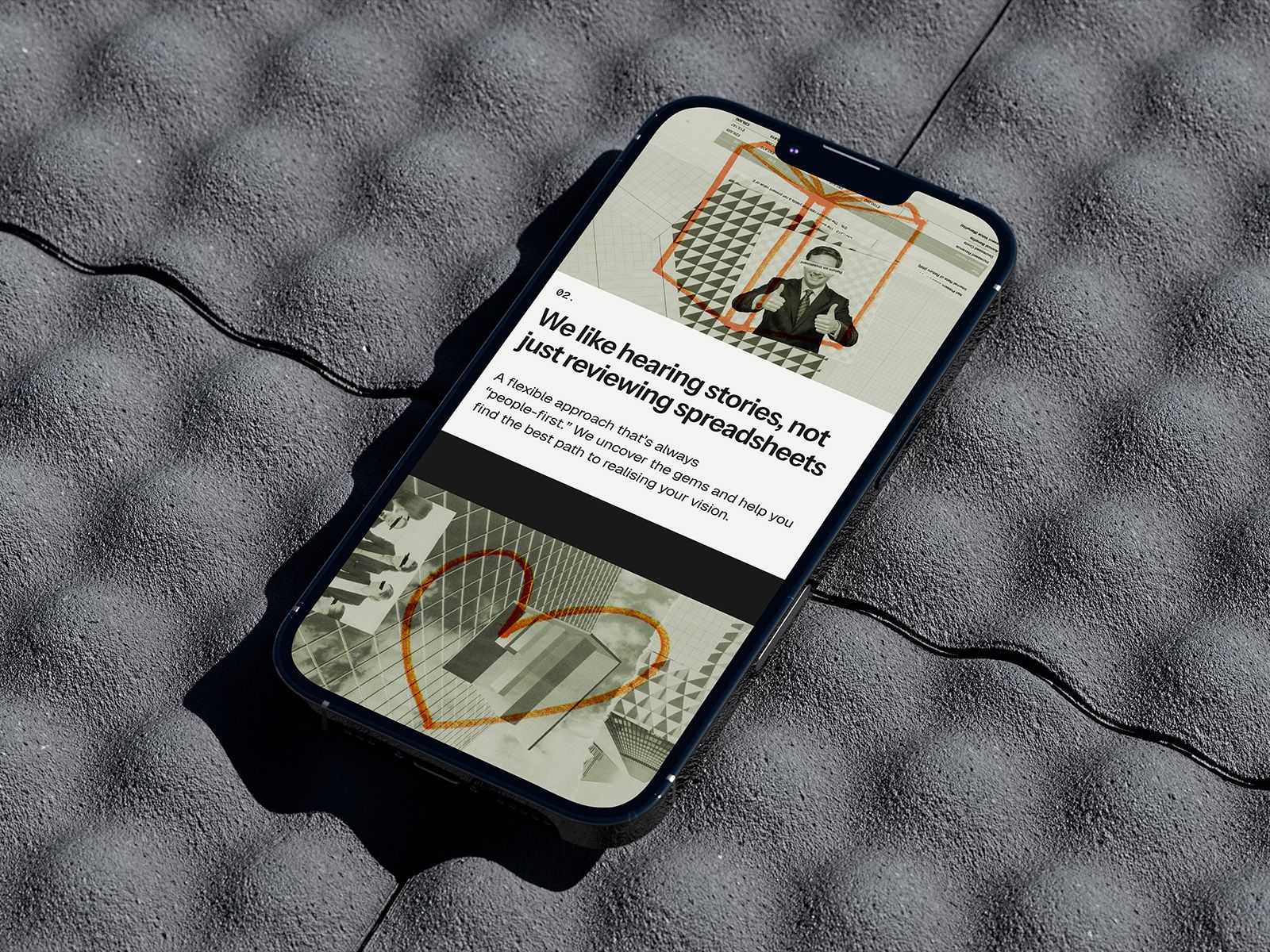 A website shown on a phone lying on textured grey fabric with a charging cable attached.