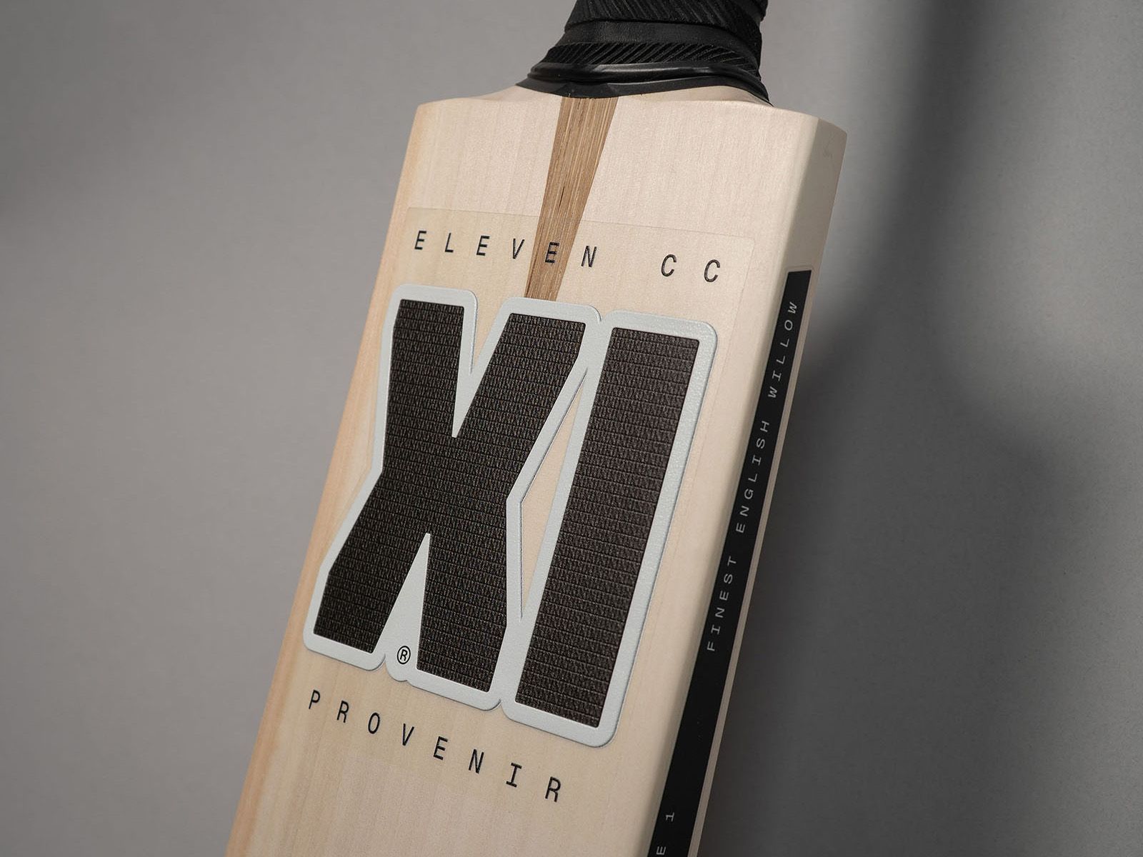 Eleven Cricket Club branding on a wooden cricket bat