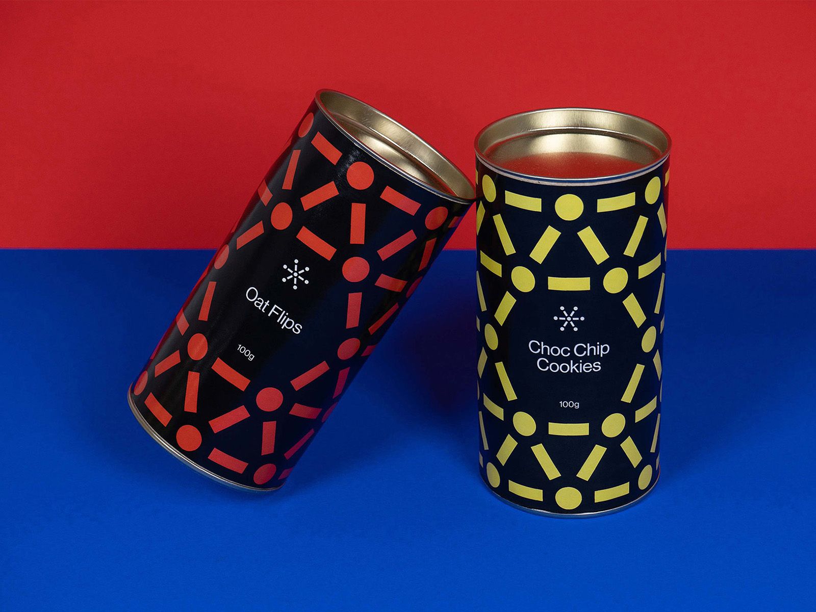 Two patterned Six Connections drink cans on a blue surface against a red background.
