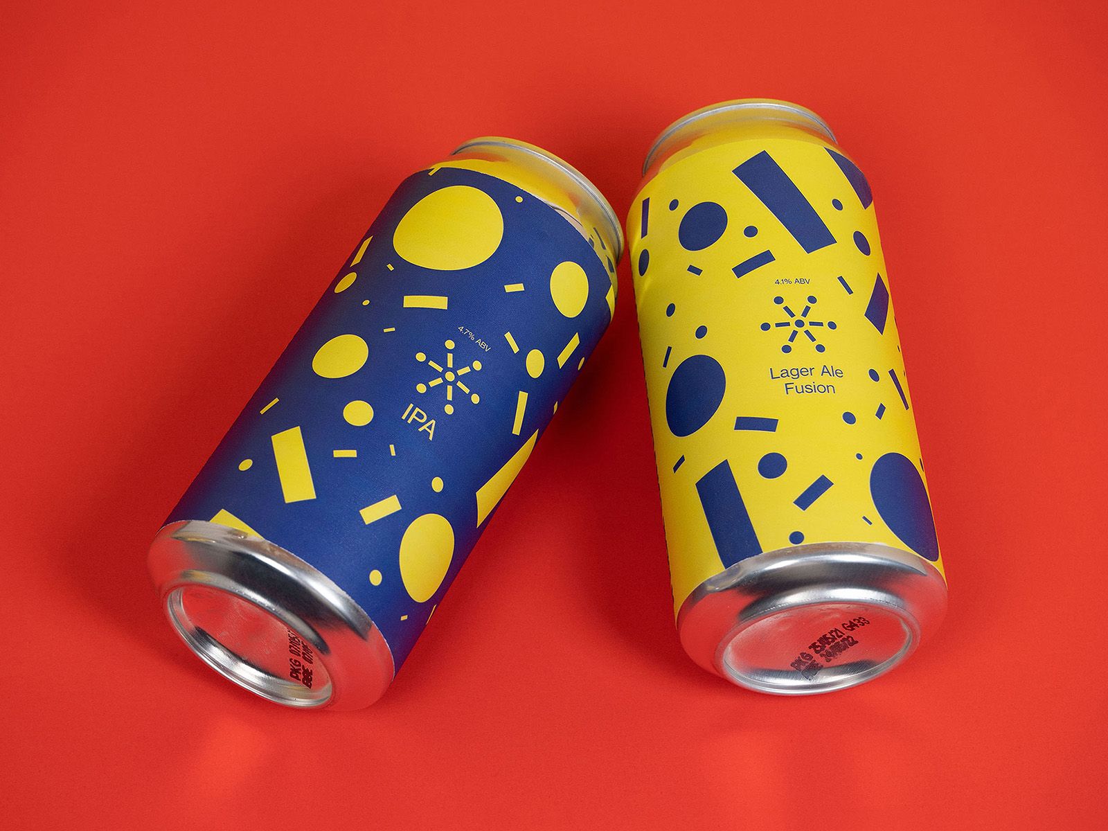 Two Six Connections drink cans in yellow and blue with playful graphic patterns on a red surface.