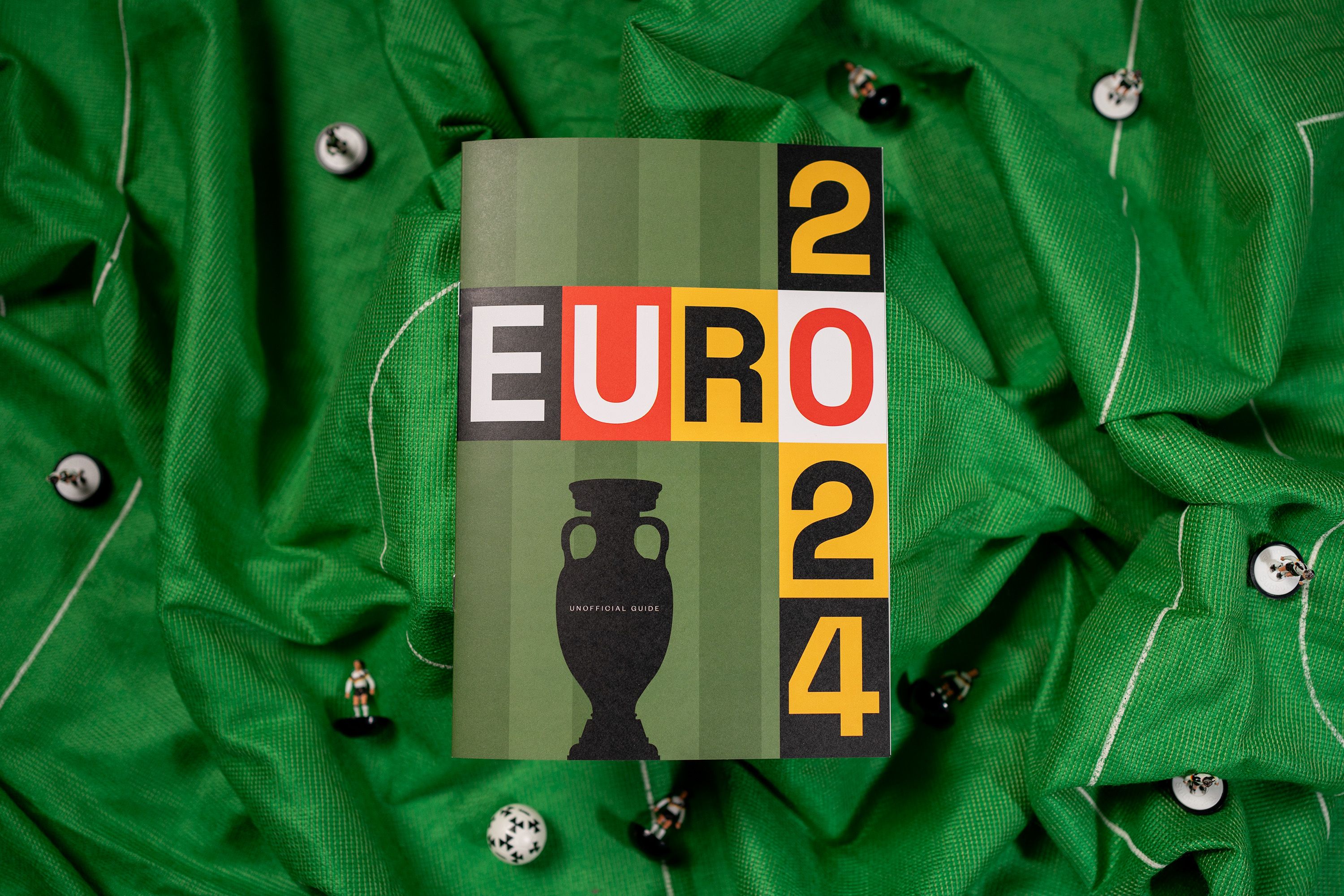 Euro 2024 editorial cover on green football shirts.