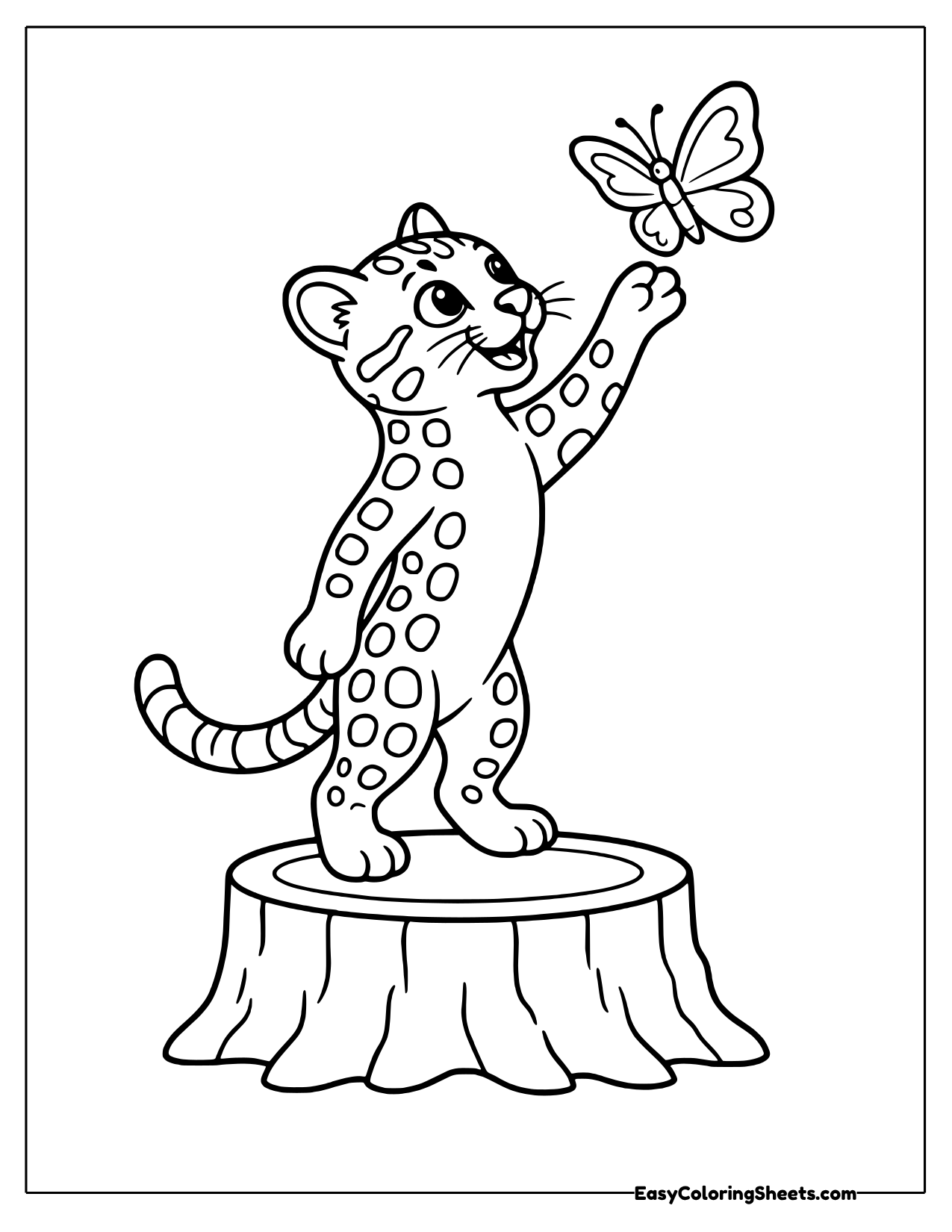 A spotted ocelot stands on its back legs on a tree stump and reaches up toward a butterfly.