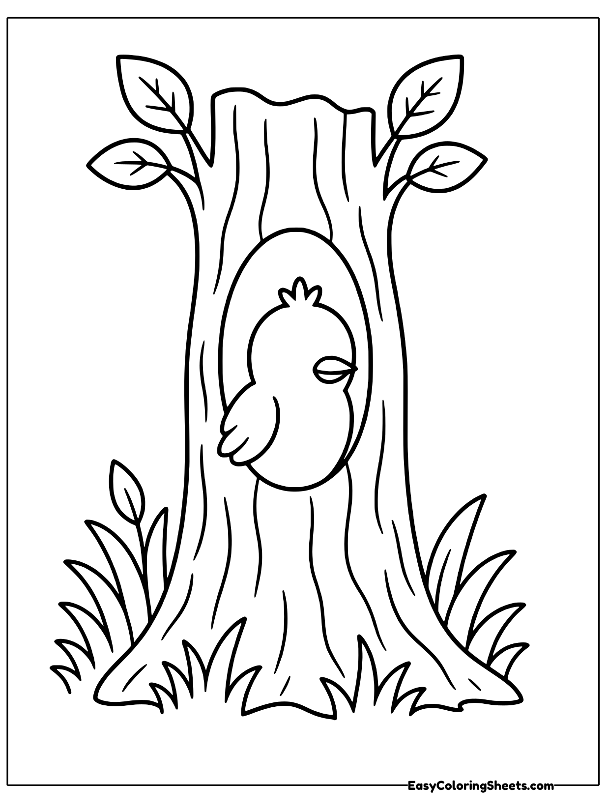 A bird peeks out of a hollow in a tall tree trunk with leafy branches on top and grass at the base.
