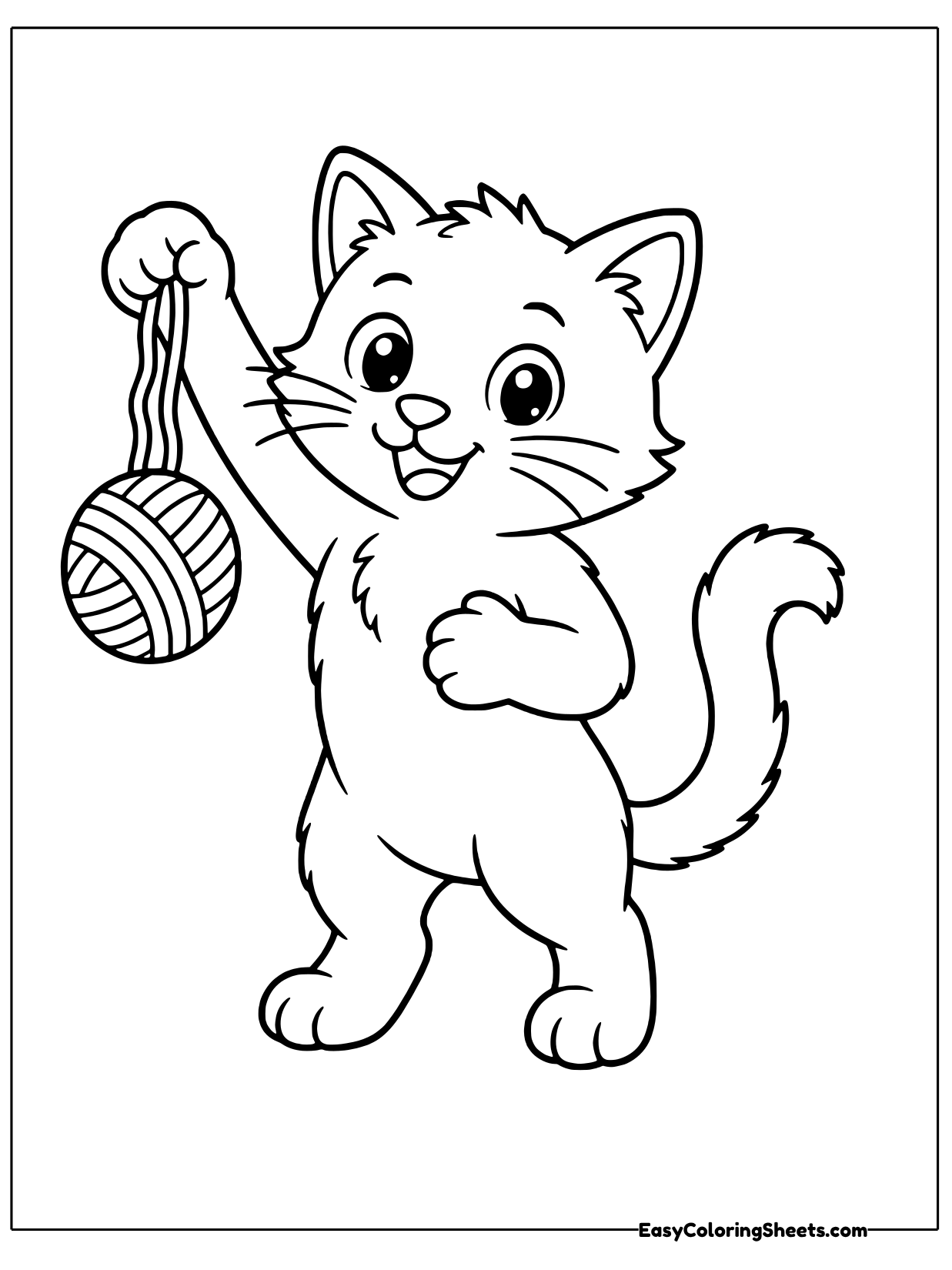 A playful kitten stands on its back legs and reaches for a ball of yarn hanging on a string.