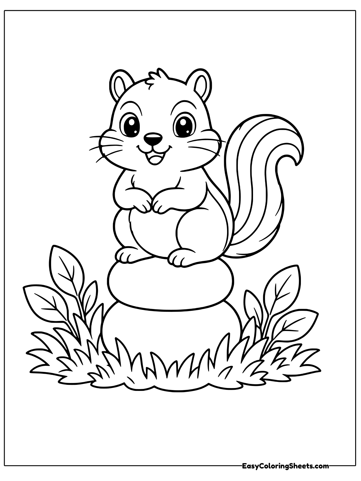 A chipmunk sits upright on top of stacked round stones in a grassy patch, holding its paws together.