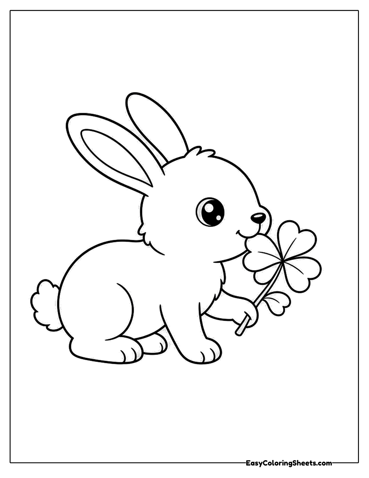 Rabbit nibbling a four-leaf clover held in its paws