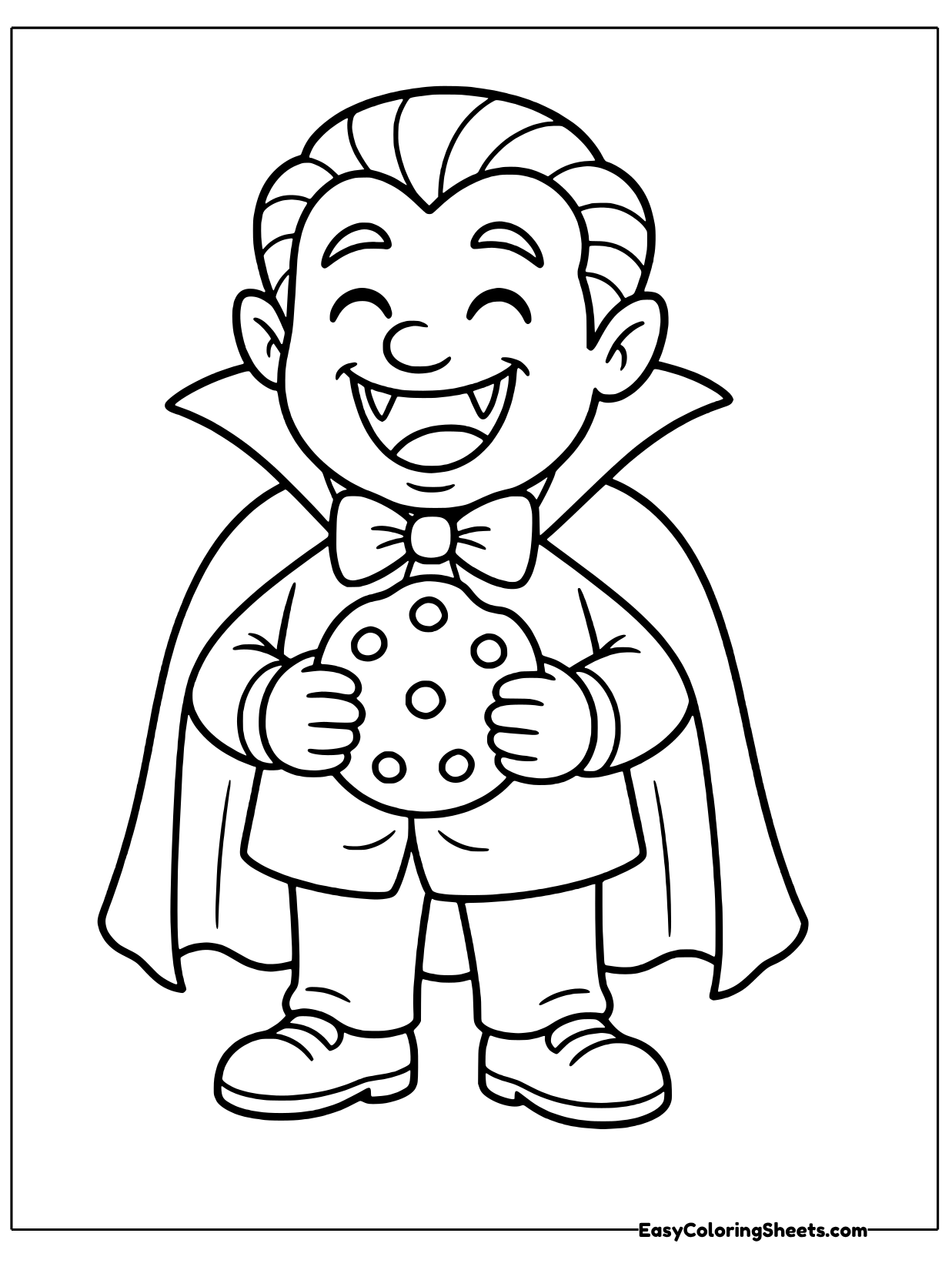 A vampire boy laughs with his eyes squeezed shut, holding a round cookie dotted with chips.