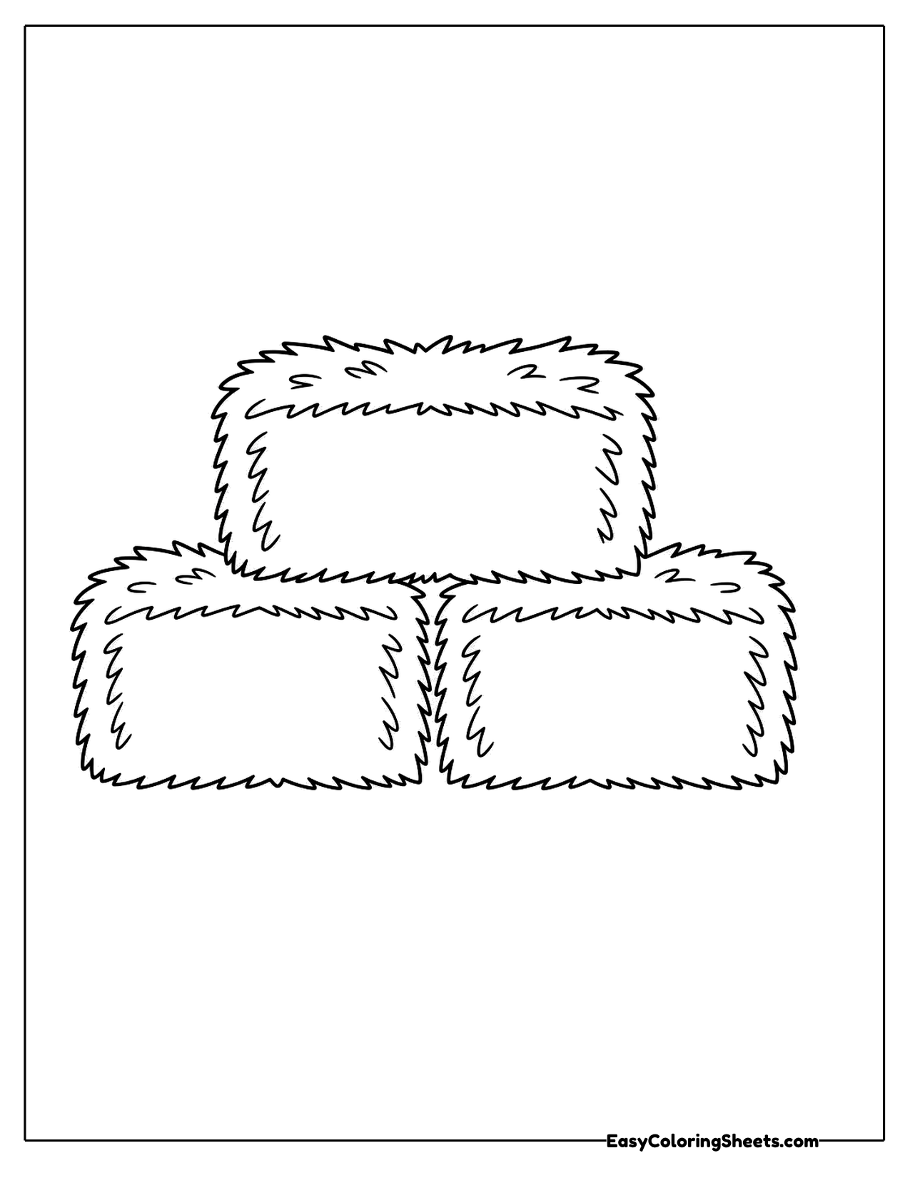 Three rectangular hay bales stacked in a pyramid