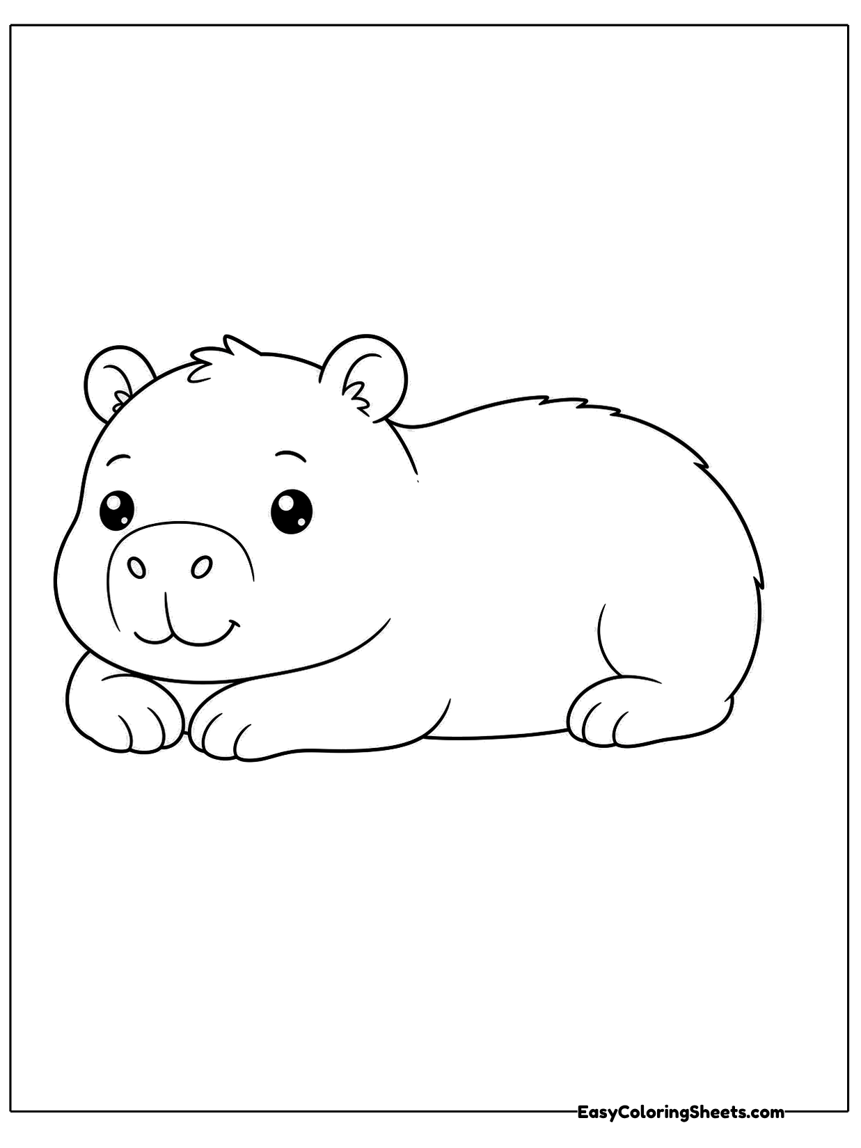 A capybara rests on its belly with its legs tucked under and a calm, sleepy expression.