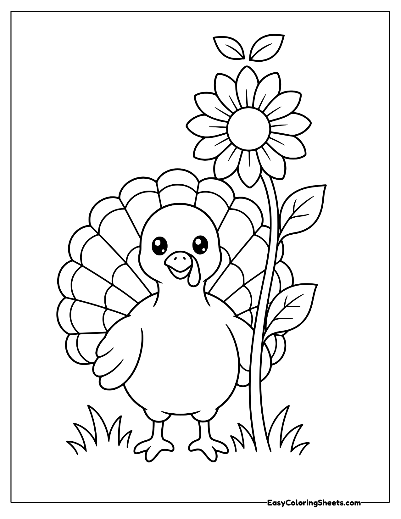 Turkey standing in the grass beside a tall sunflower