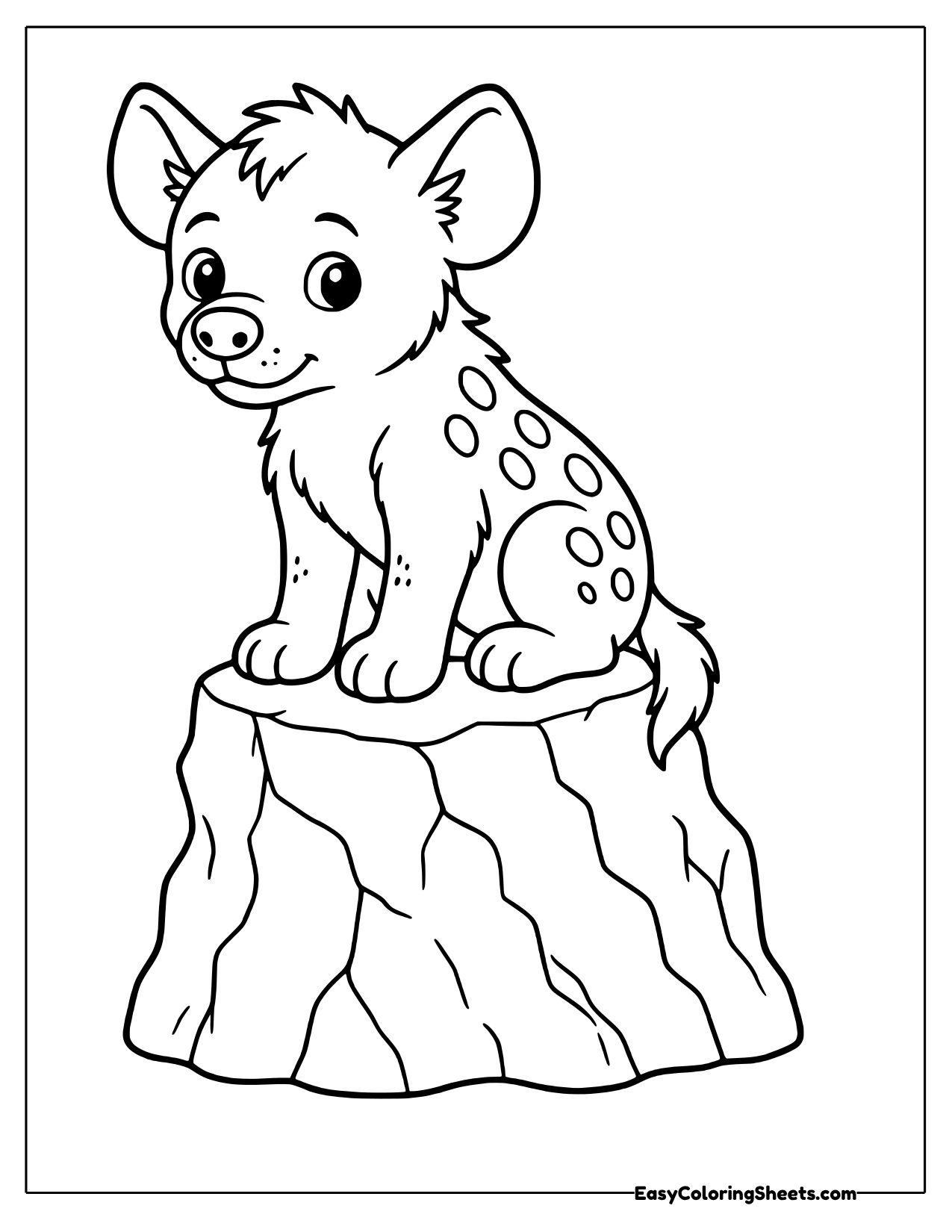 Hyena cub sitting on a tree stump