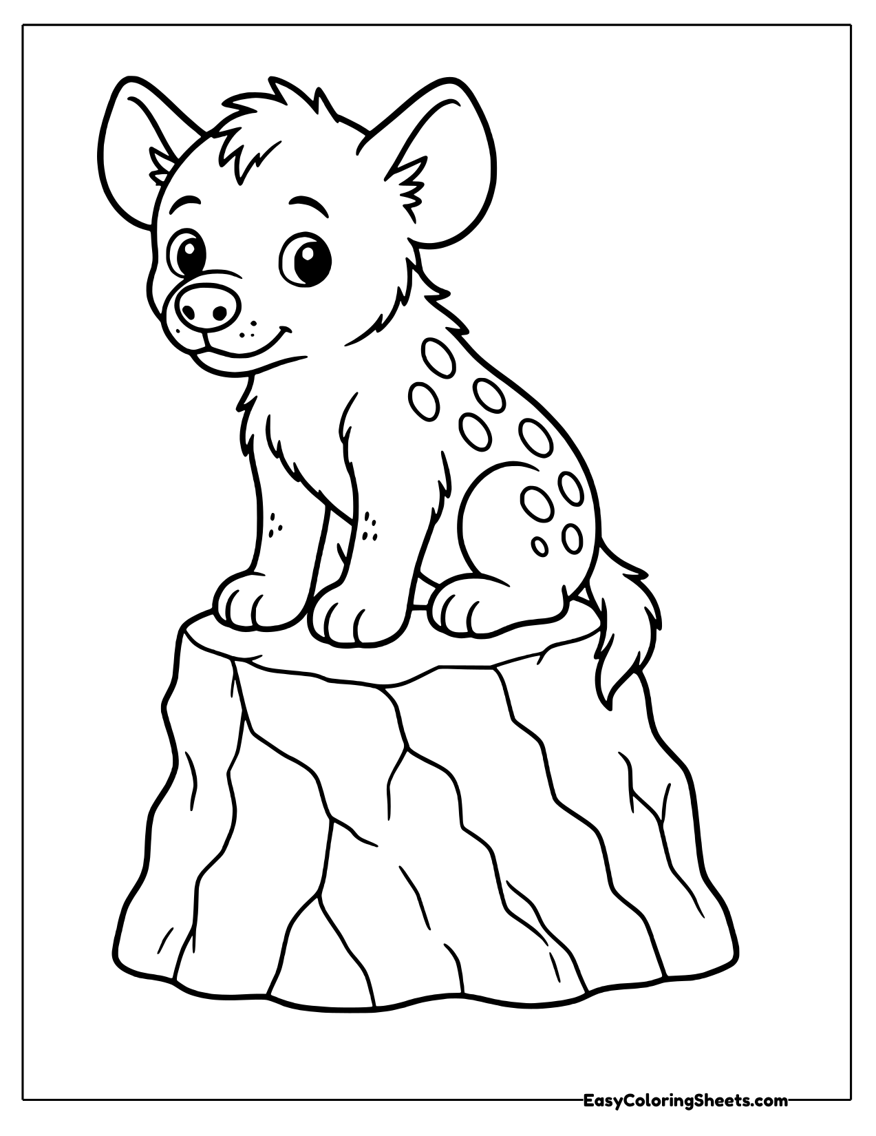 Hyena cub sitting on a tree stump