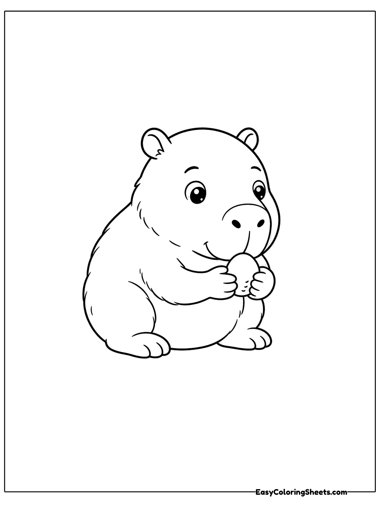 A capybara sits with a tiny pebble held up near its mouth, looking curious.