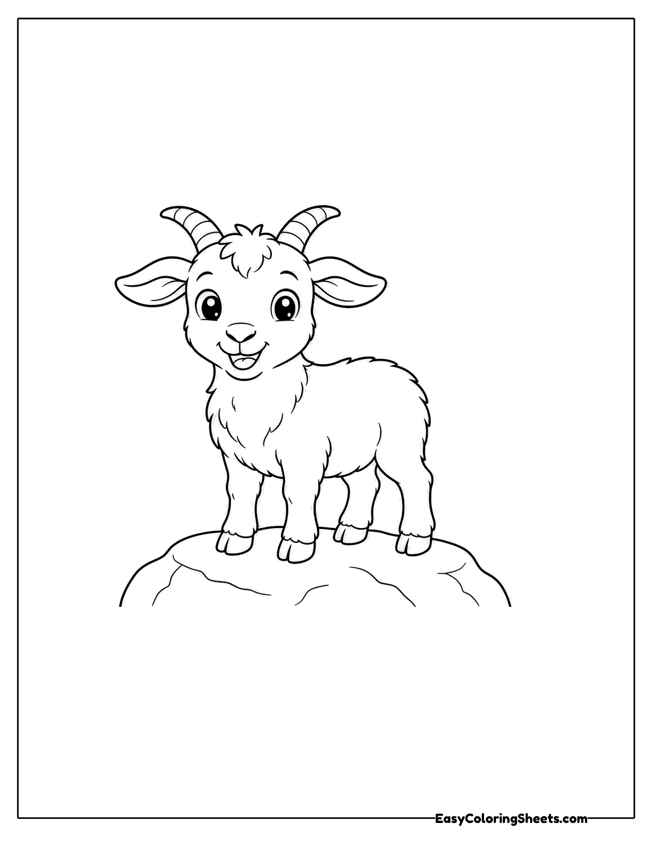 Little goat standing on top of a rounded rock