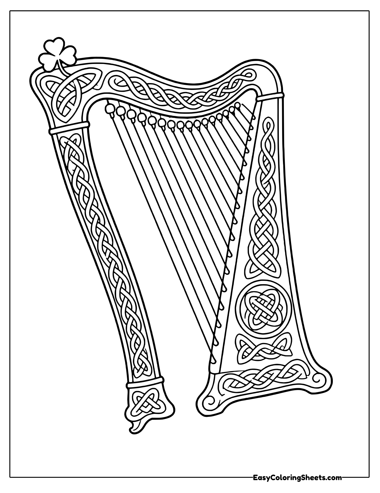 Tall Celtic harp decorated with knotwork patterns and a small shamrock