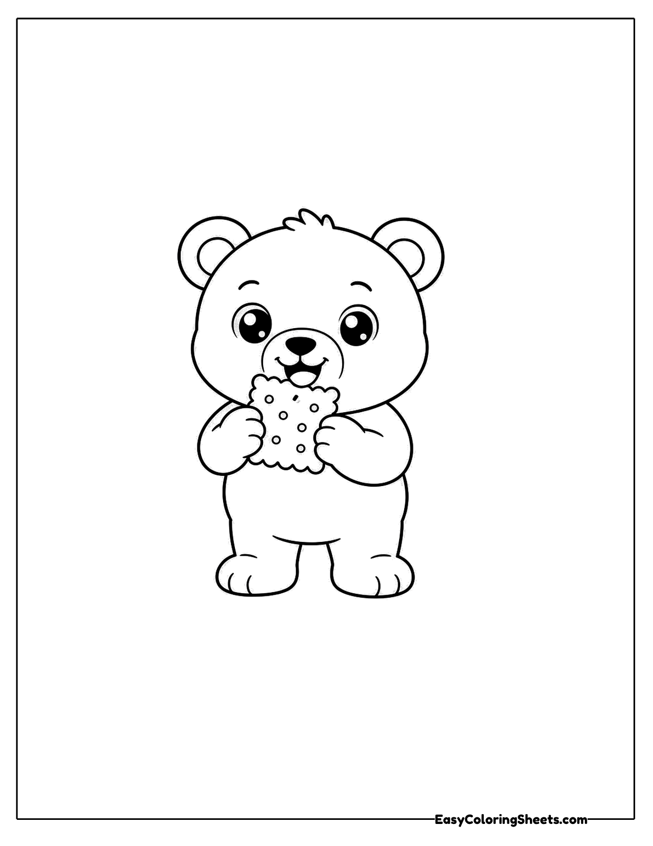 Little bear nibbling a cookie