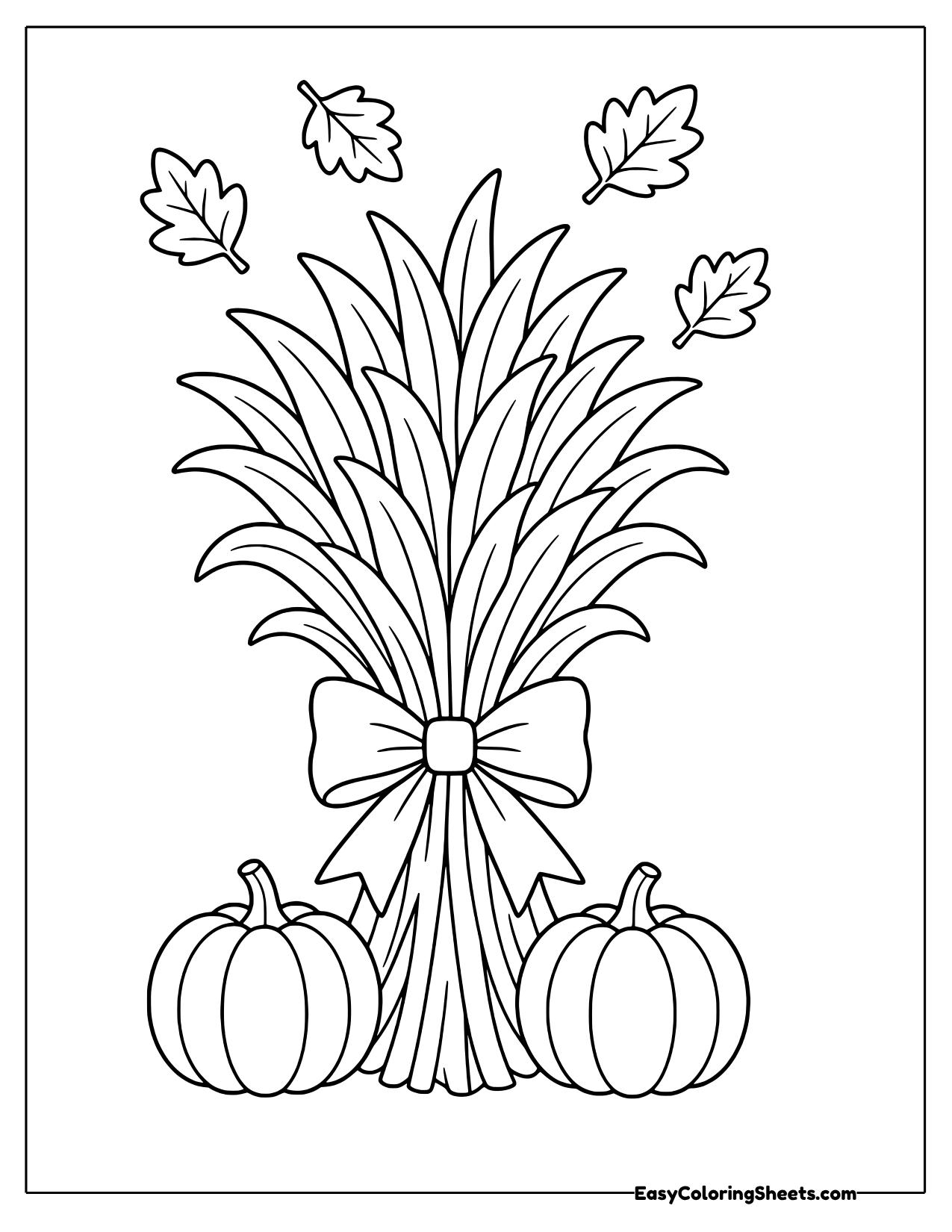 Corn stalk bundle tied with a bow between two pumpkins