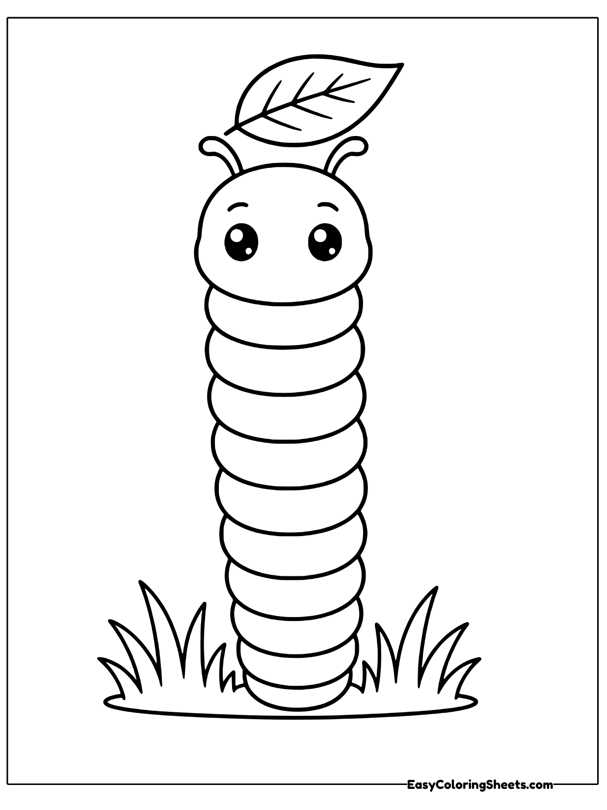 A caterpillar stands straight up in a tuft of grass with a leaf perched on its head like a hat.
