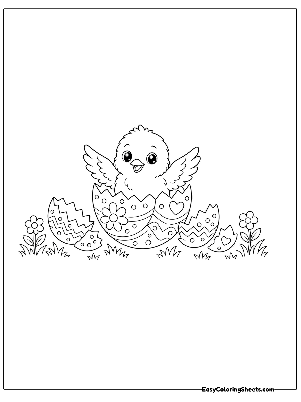A fluffy chick pops out of a decorated Easter egg, sitting in a patch of grass and flowers.