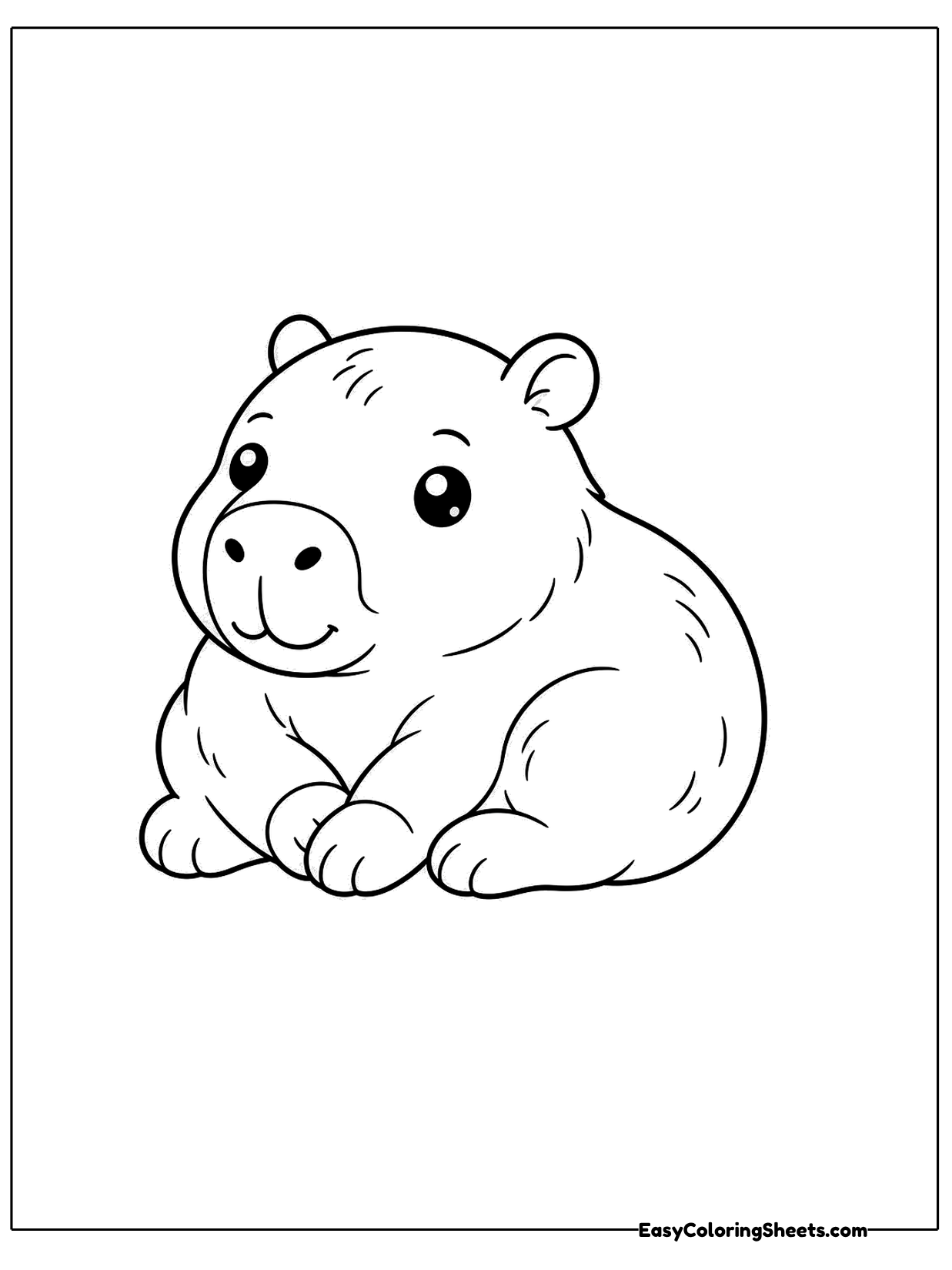 A capybara curls up on the ground with its legs tucked under and its head turned toward the viewer.